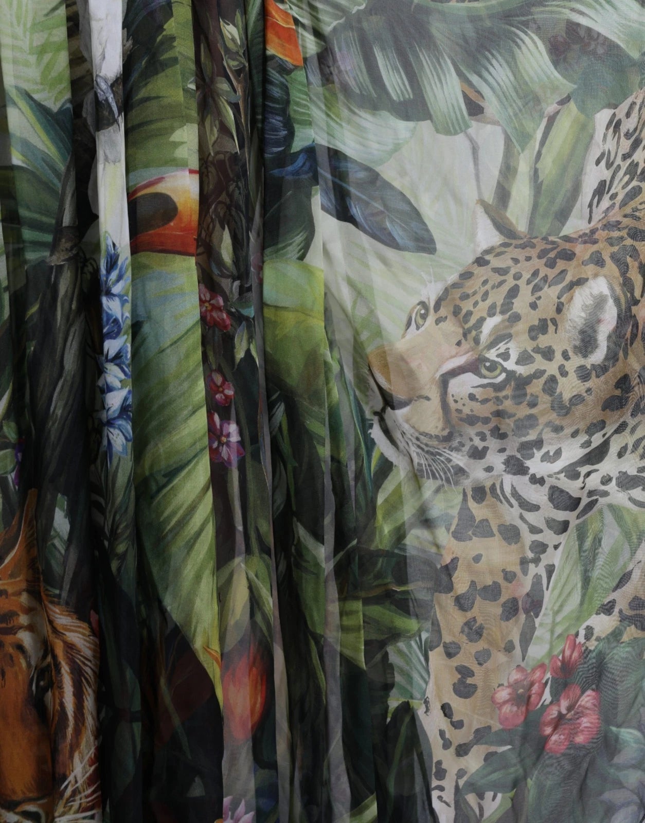 A multicolored silk jungle print maxi dress with a leopard face