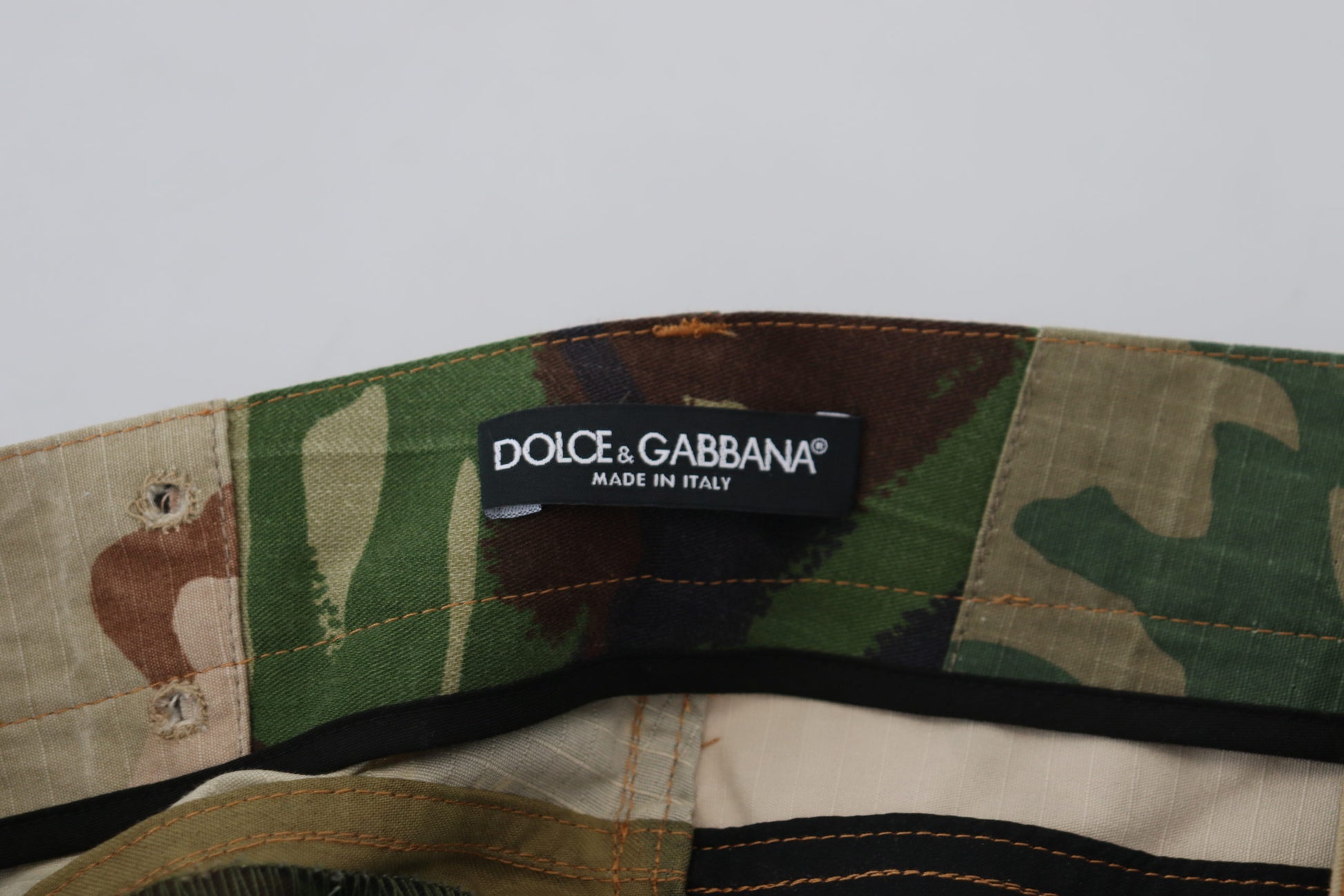 Camouflage pants with a brand label on the waistband