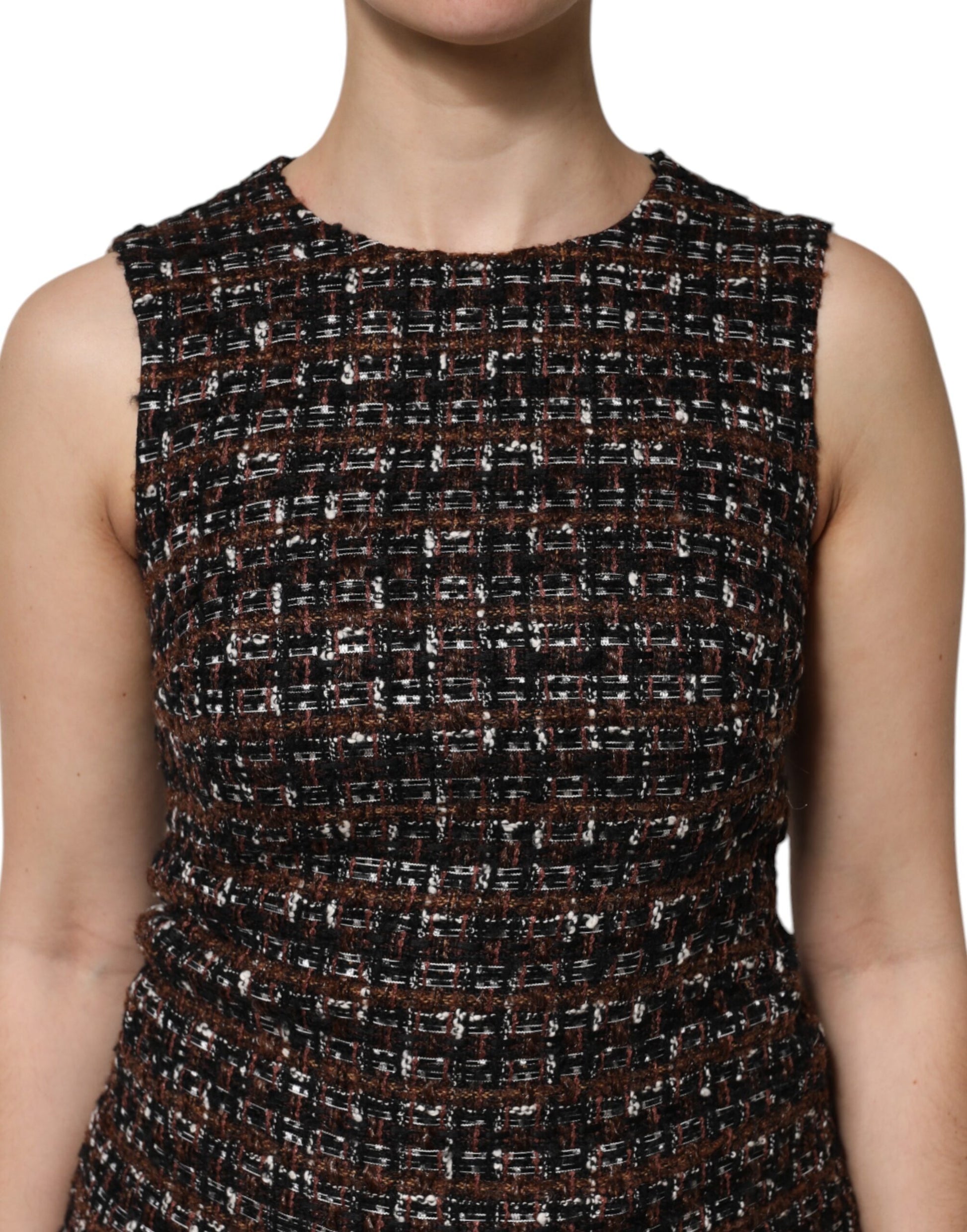 A sleeveless mini dress with an A-line silhouette. It features a multicolored tweed fabric and is designed by