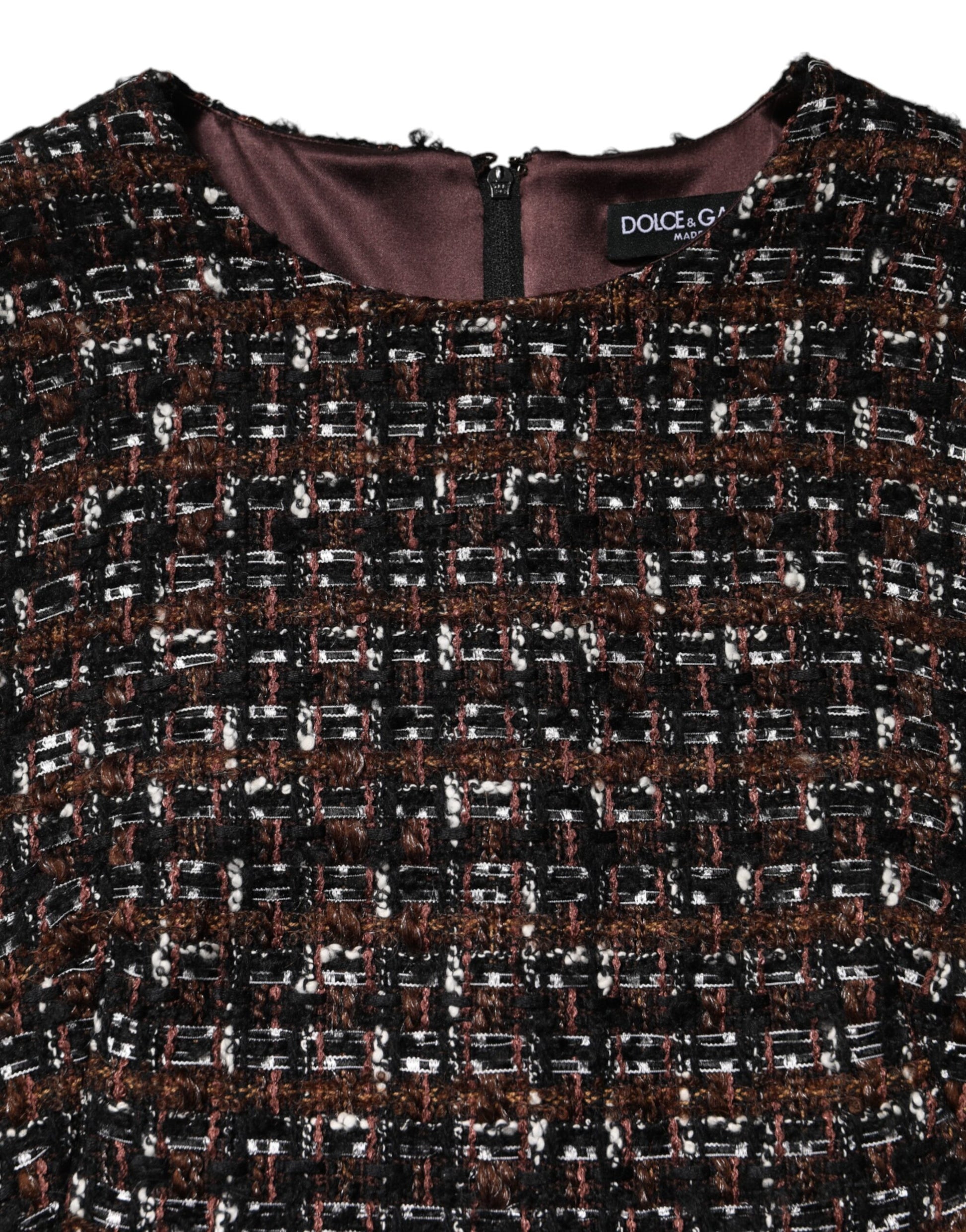 A sleeveless mini dress with an A-line silhouette. It features a multicolored tweed fabric and appears to be