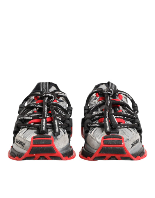 Pair of men's sneakers with red and black laces, white soles, and multicolored upper