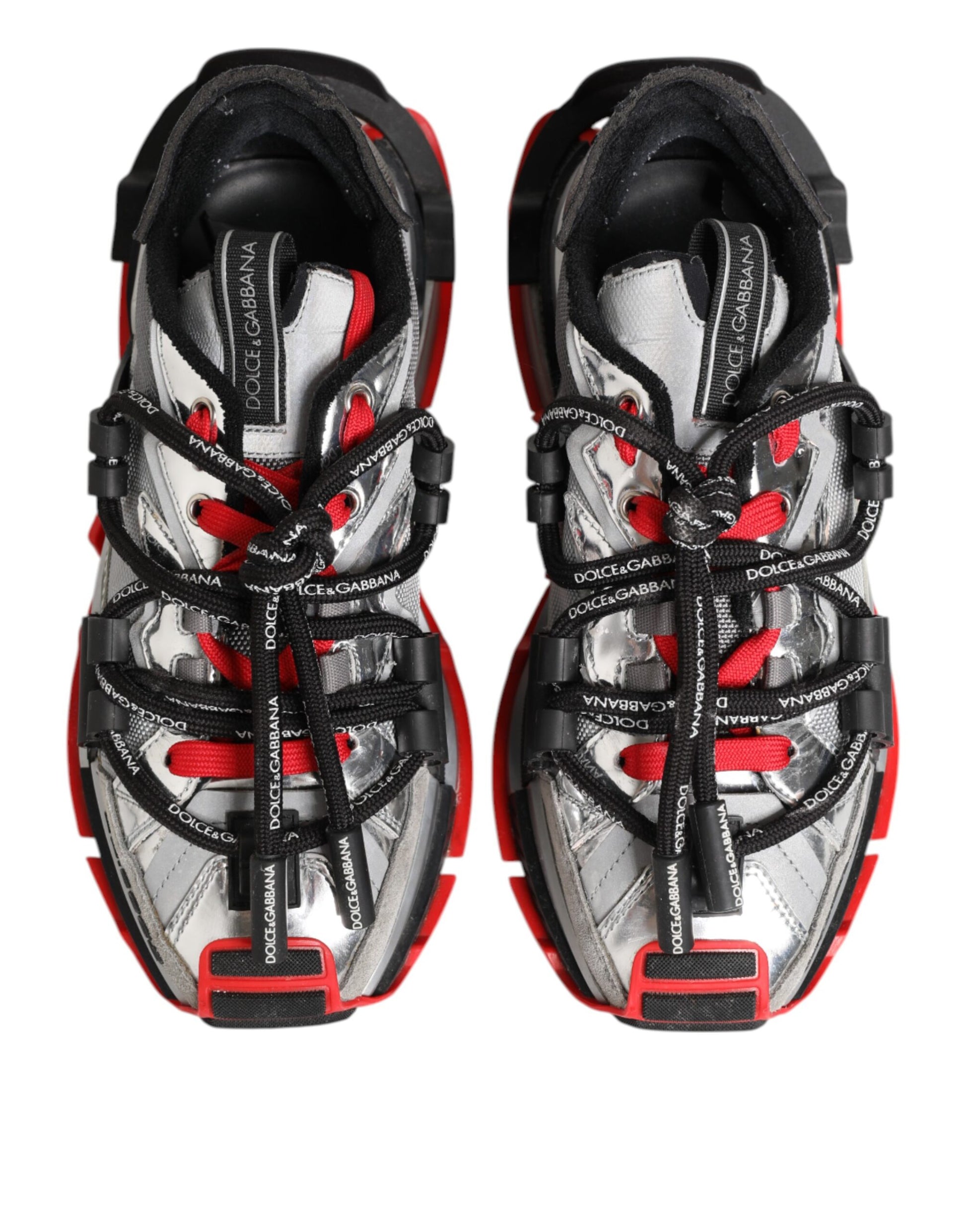 Pair of men's sneakers with red and white laces, black straps, and a silver buckle