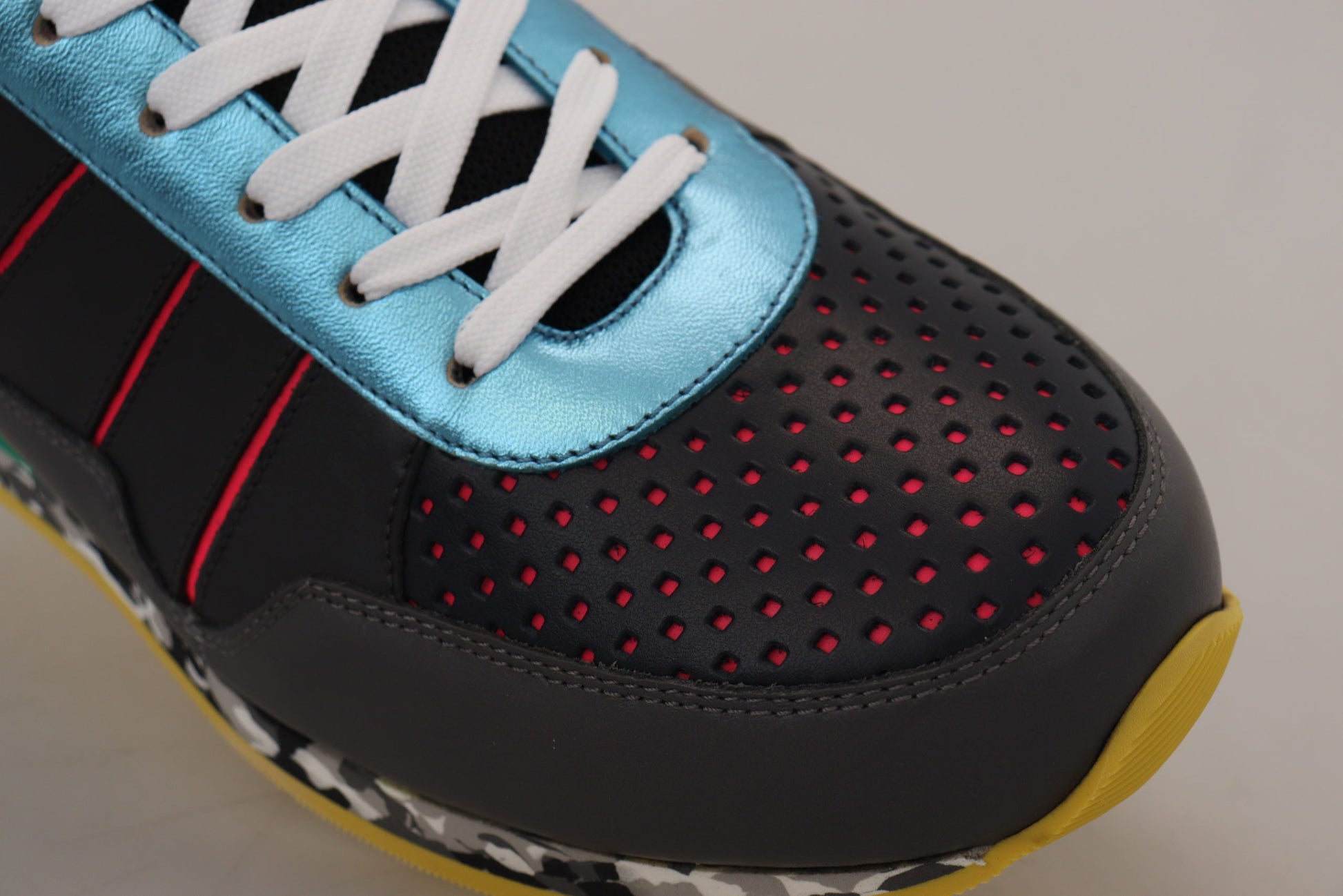 Pair of athletic shoes with red and blue accents, white laces, and a patterned sole