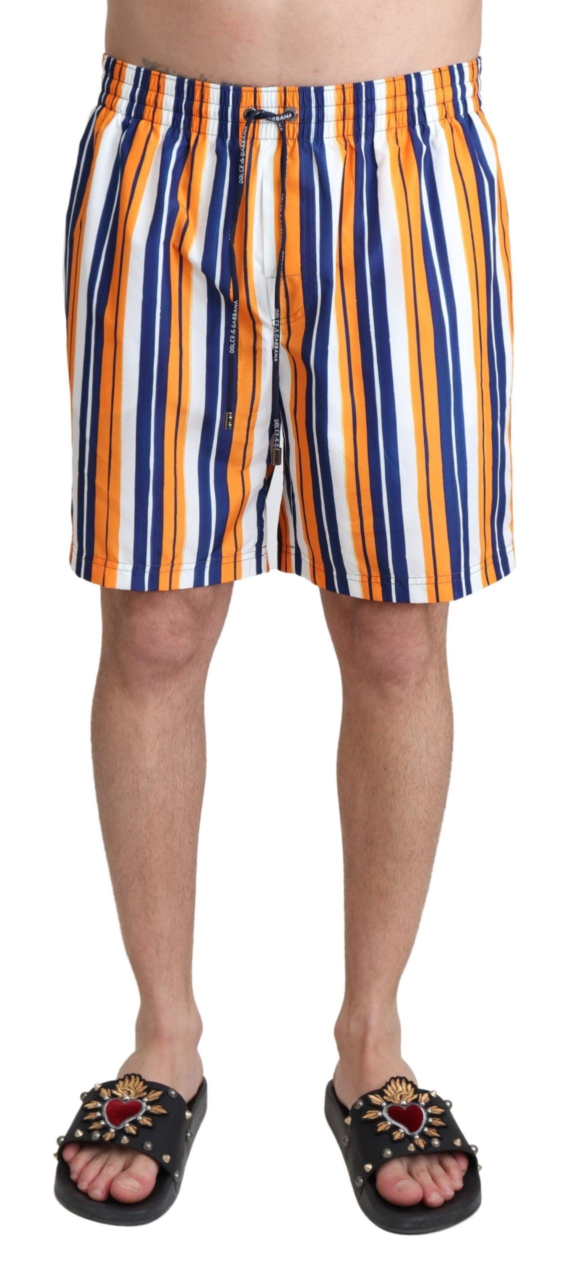 Men's swim trunks in orange, white, and blue stripes