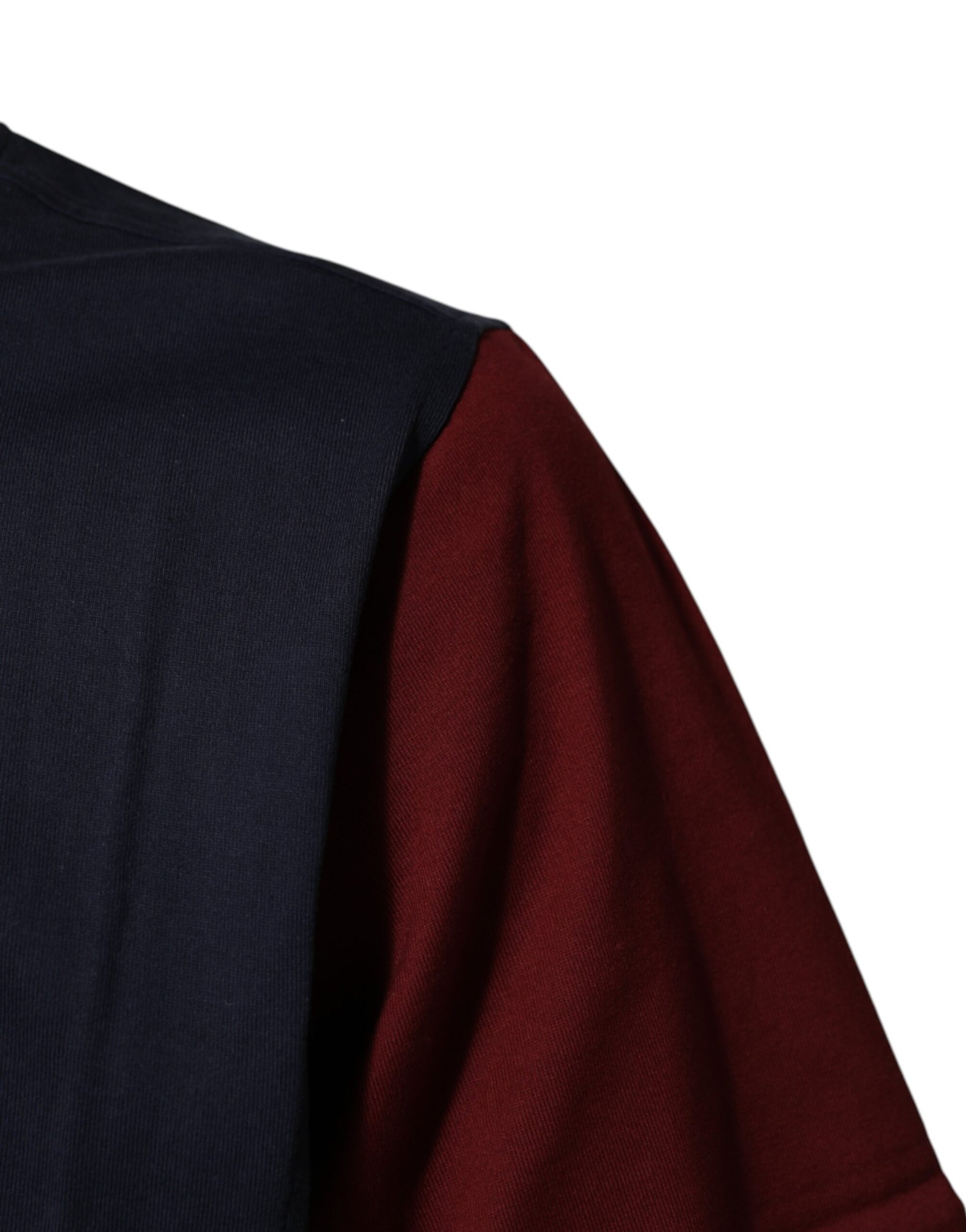 Sleeve of a dark blue sweater with red trim
