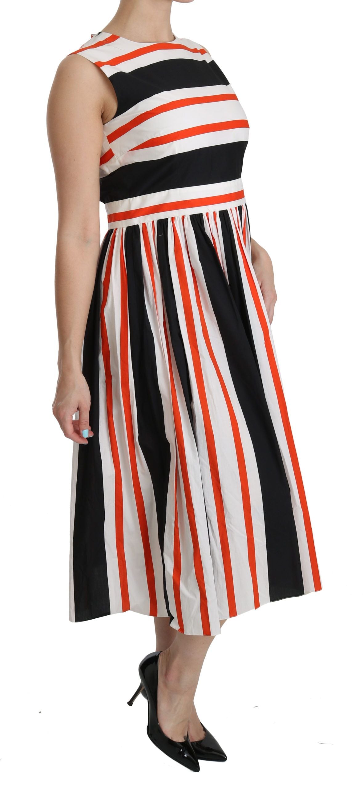 A woman wearing a midi dress with a pleated skirt and a striped pattern