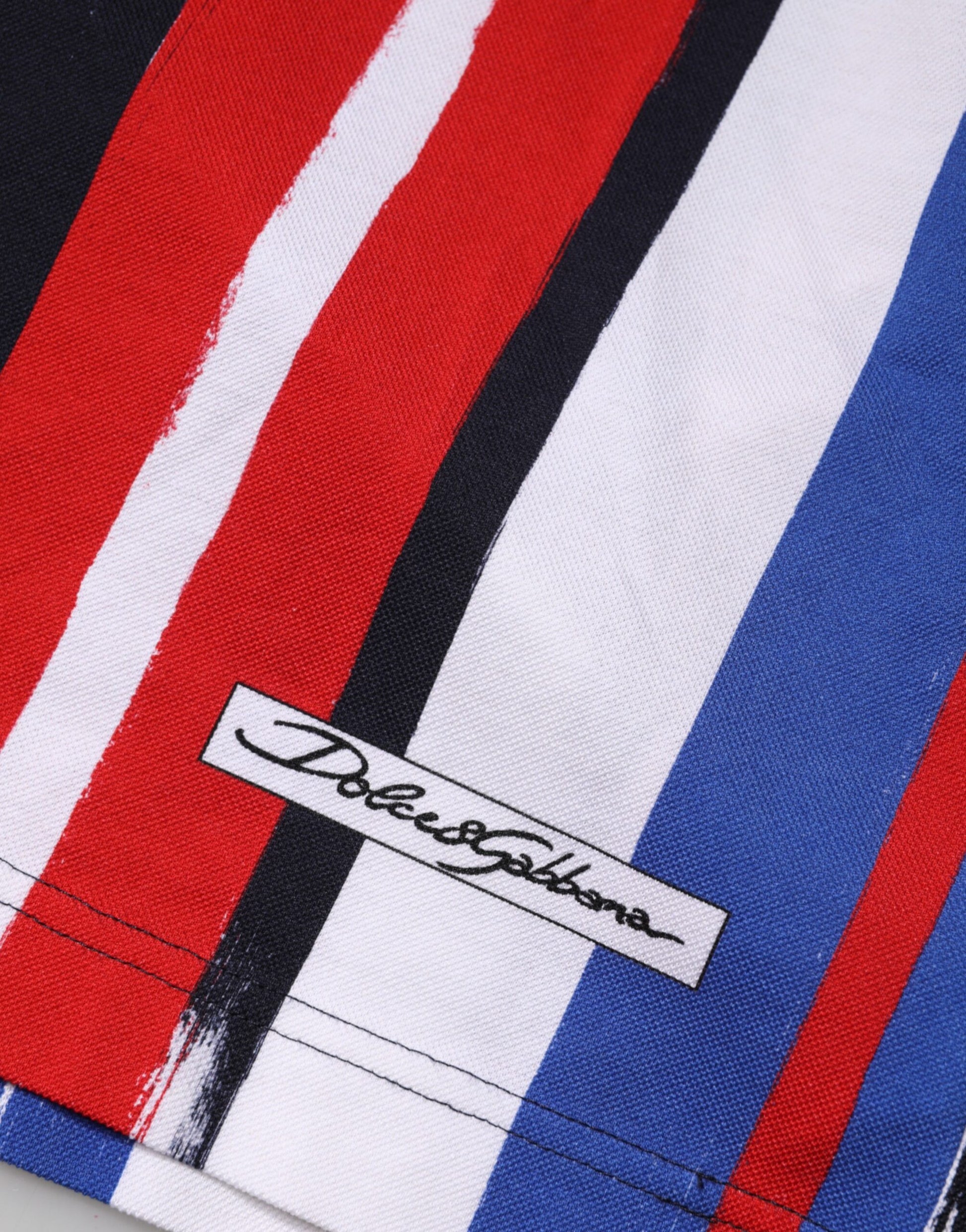 Red white and blue striped towel with a signature label