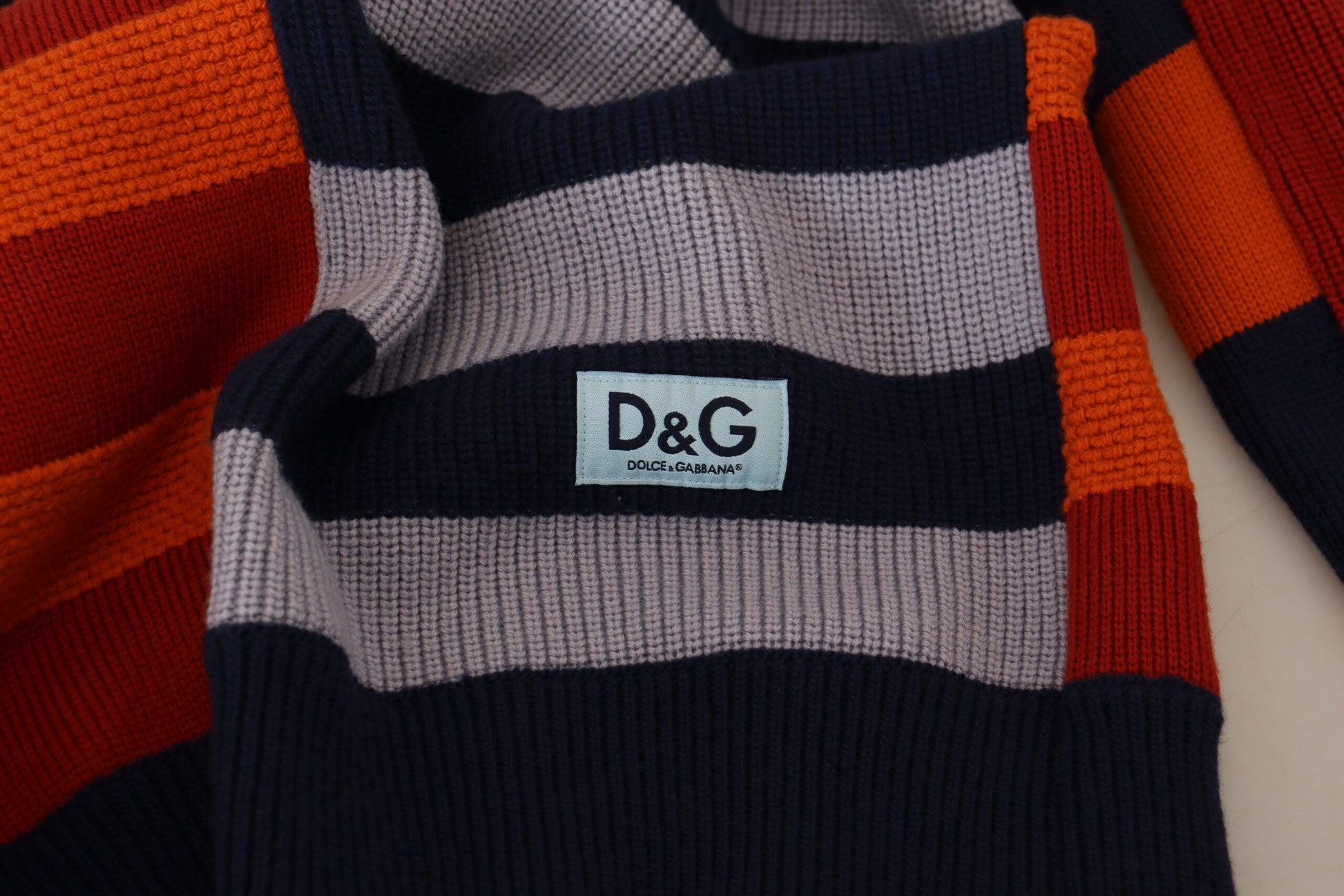 Striped knit sweater with a tag on the front