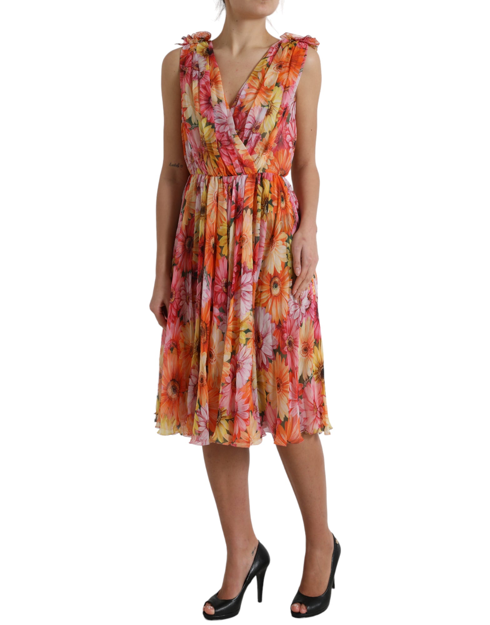 A woman wearing a multicolored sunflower print silk midi dress