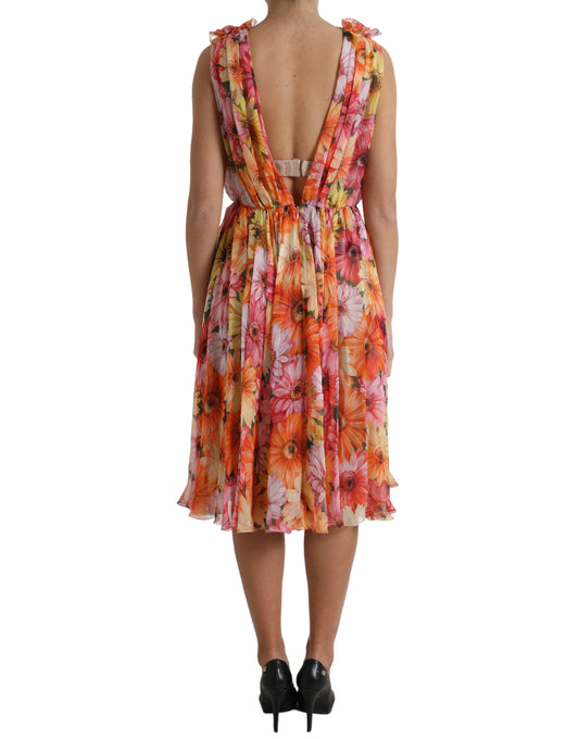 A woman wearing a multicolored floral print midi dress with a backless design