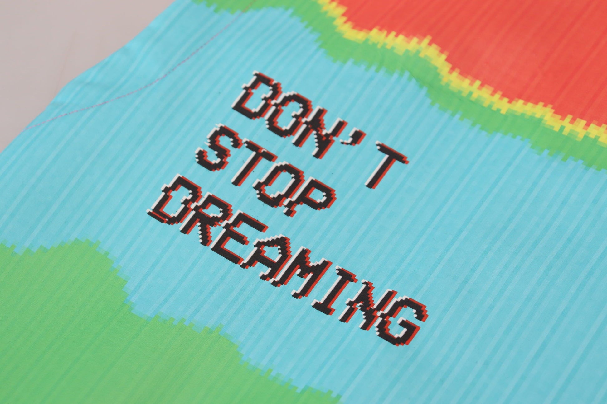 Colorful fabric with embroidered motivational quote
