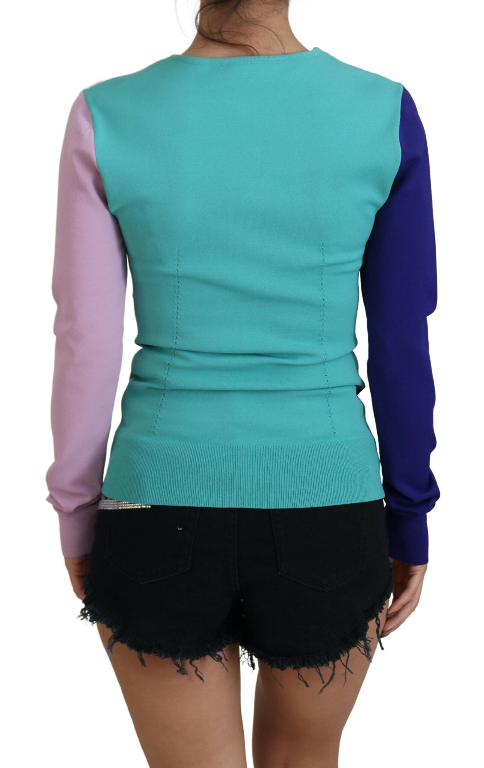 Woman wearing a colorful sweater vest over shorts