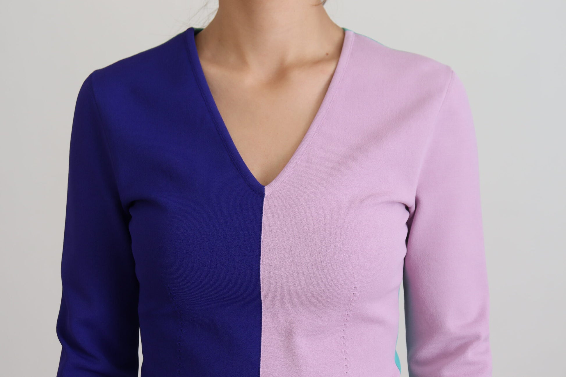 Woman wearing a blue and pink striped sweater