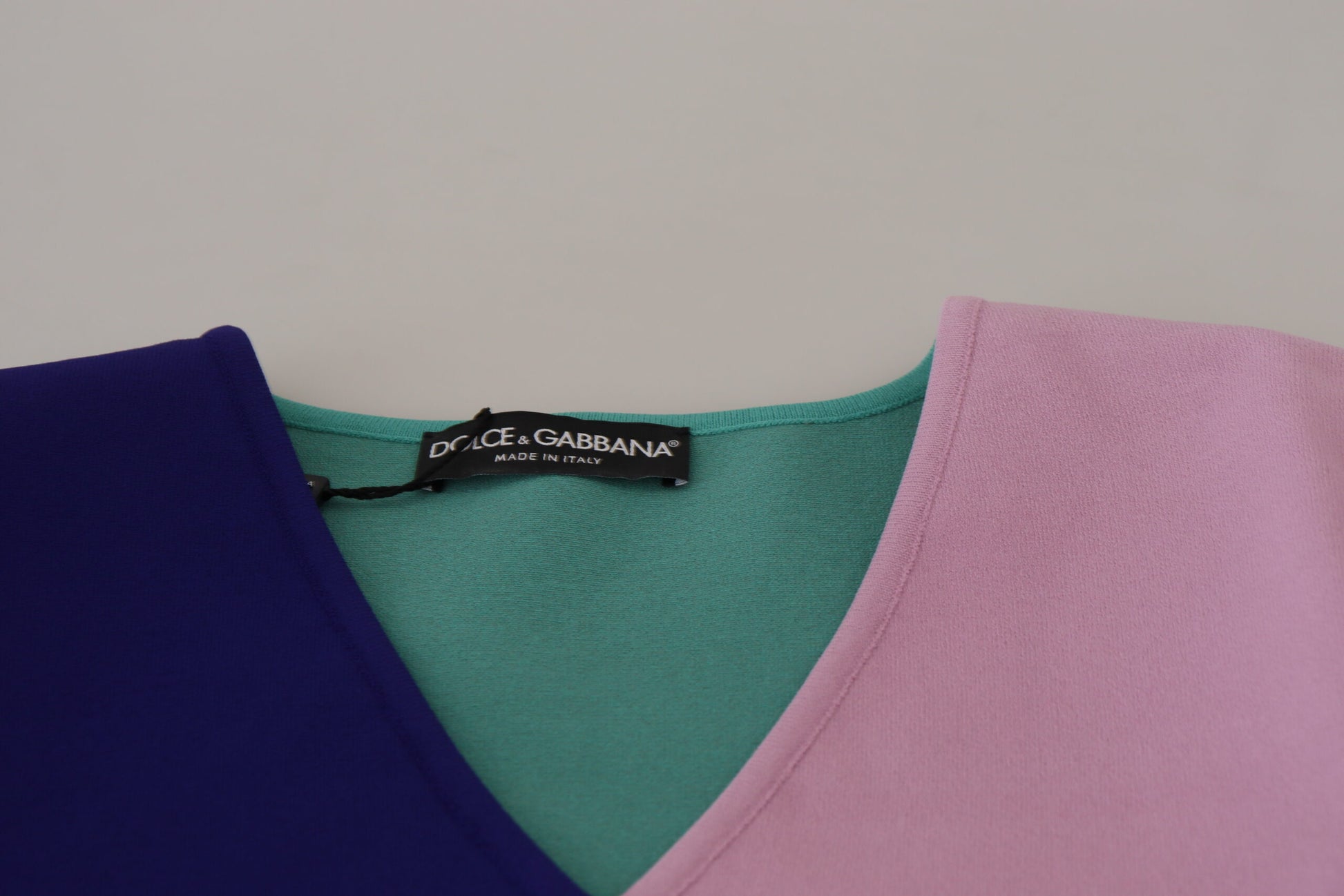 Stack of colorful v-neck t-shirts on display
