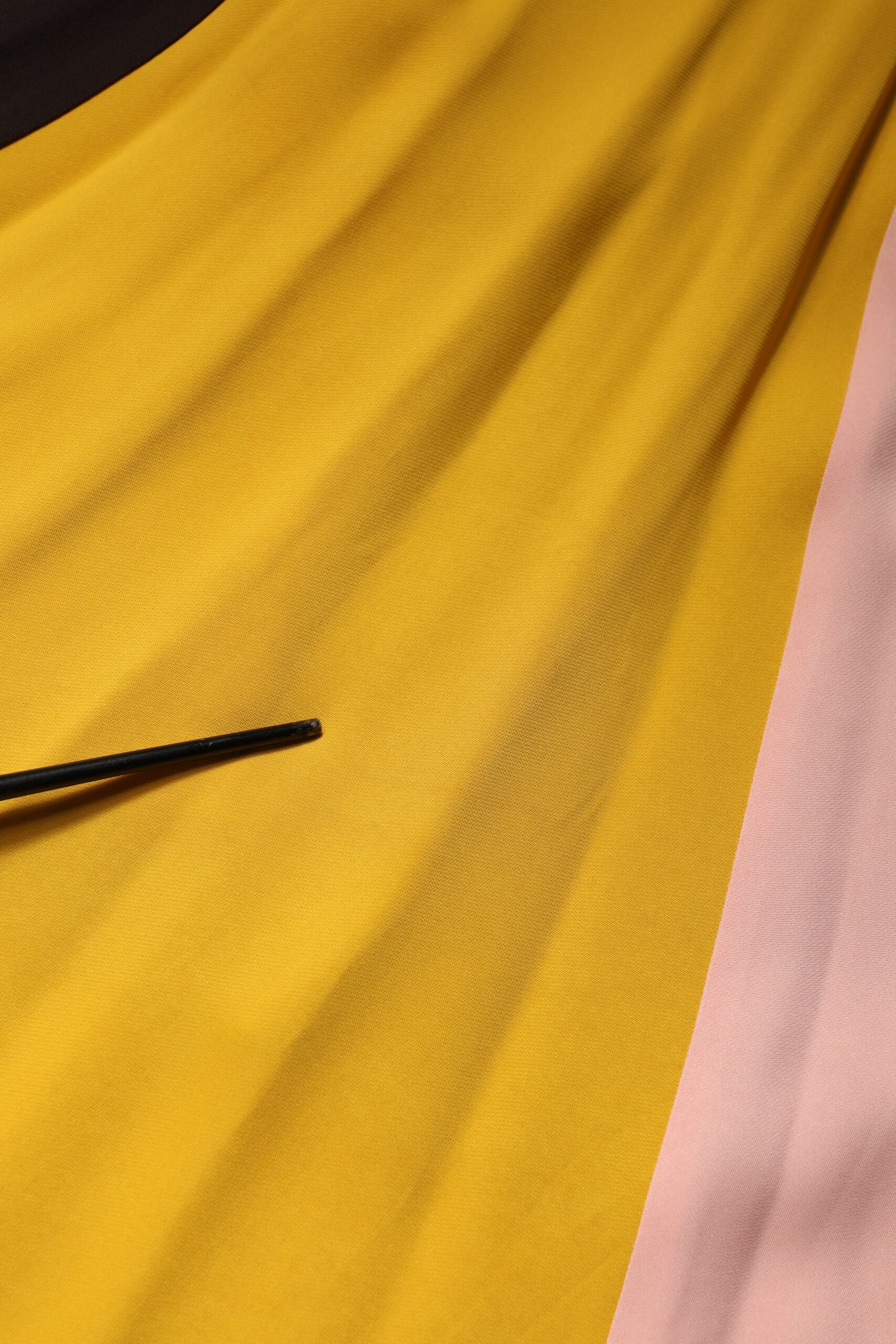 Yellow fabric with black stitching