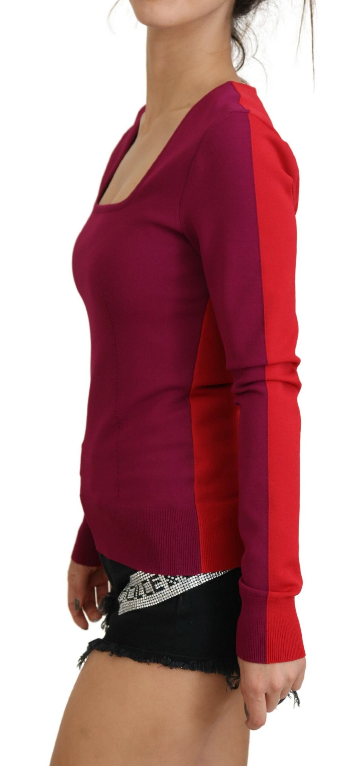 Woman wearing red sweater and black shorts