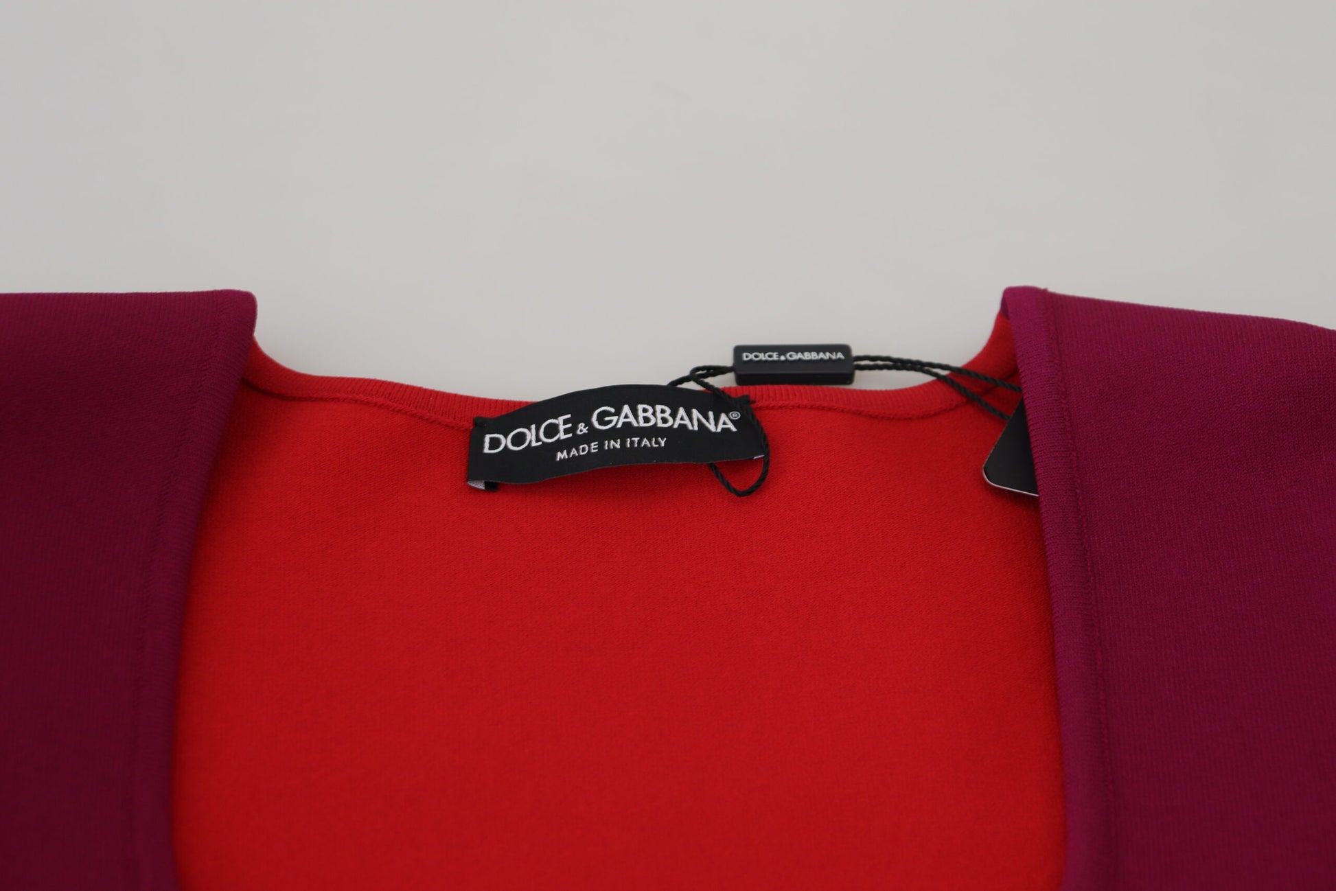 Red sweater with black tag on neckline