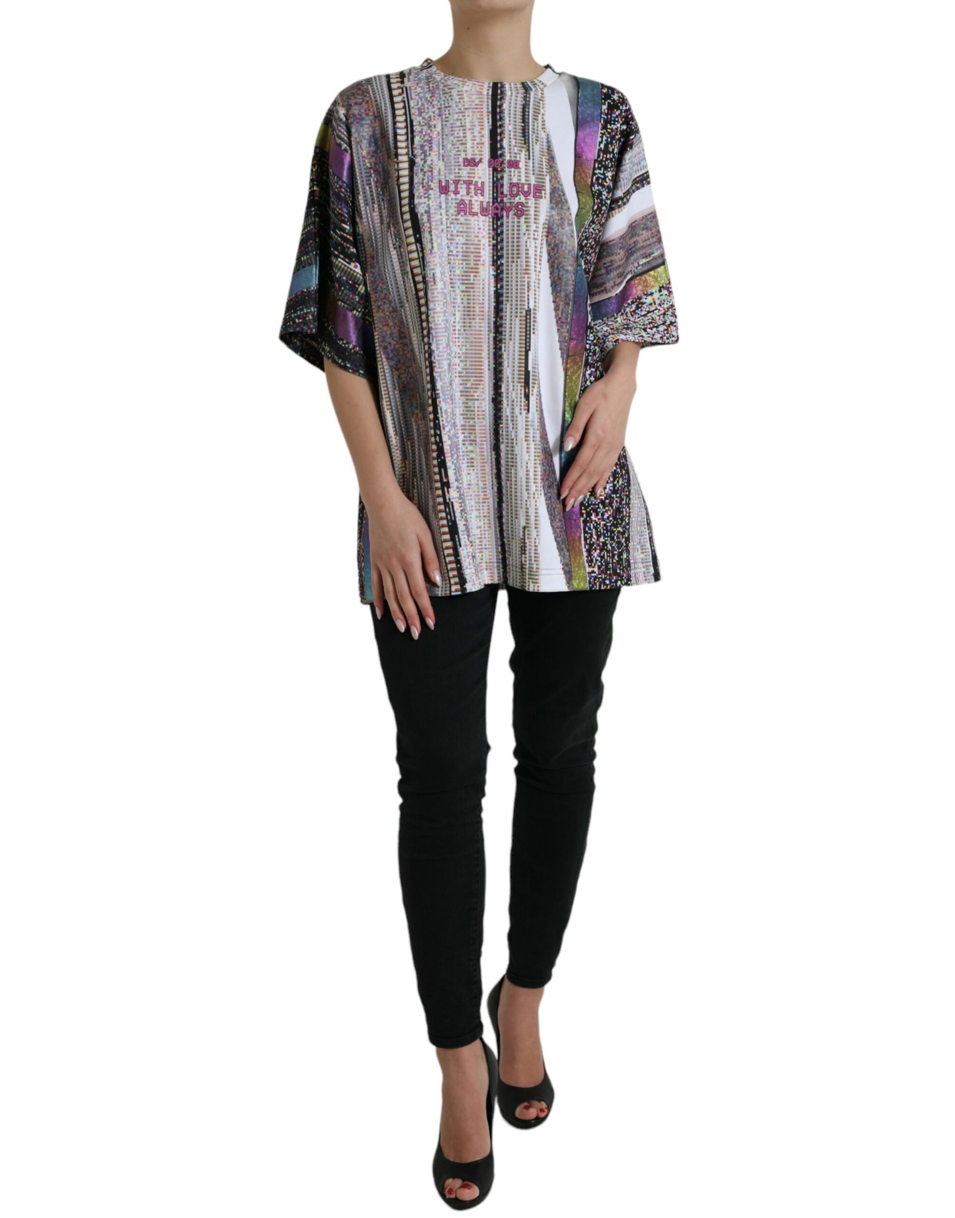 Woman wearing a colorful patterned top and black pants
