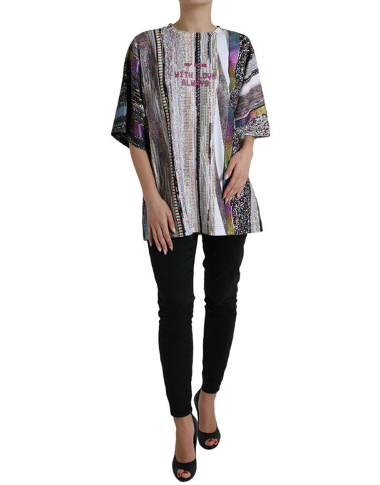 Woman wearing a colorful patterned top and black pants