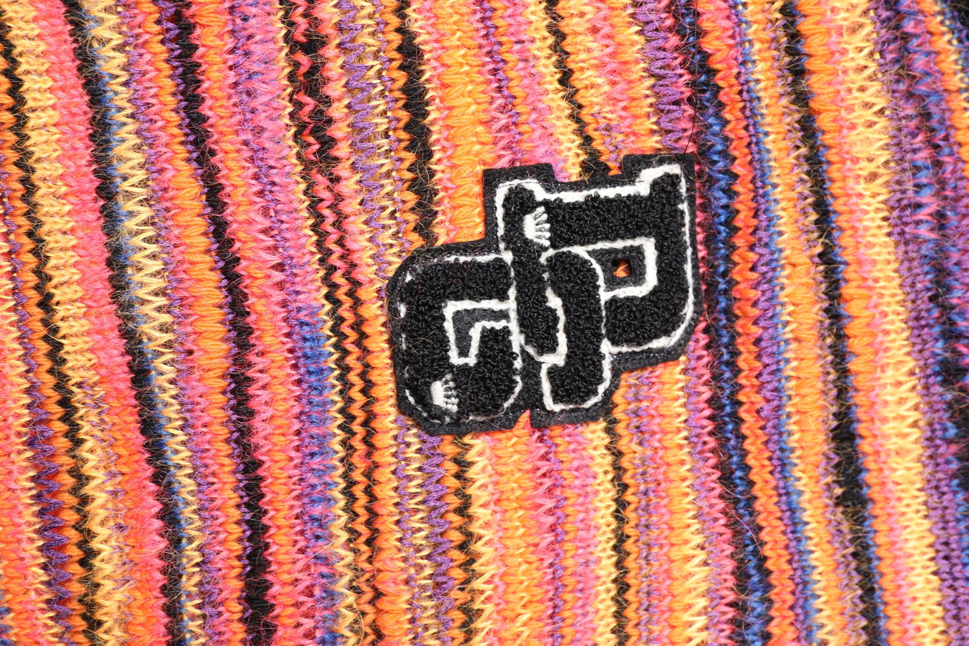 Colorful fabric with a logo embroidered on it