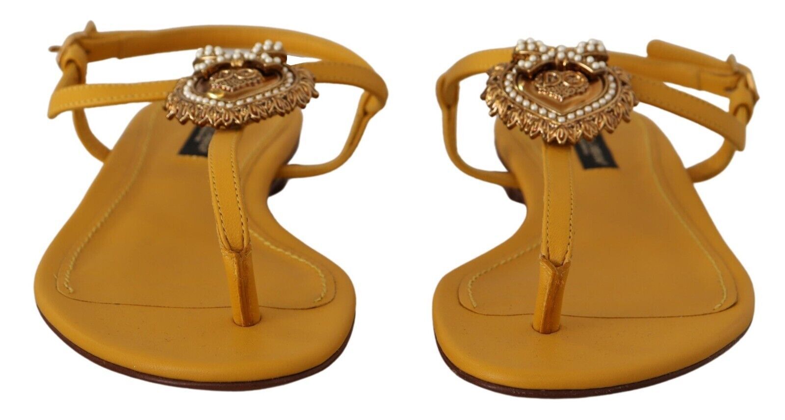 Pair of yellow sandals with embellishments and straps