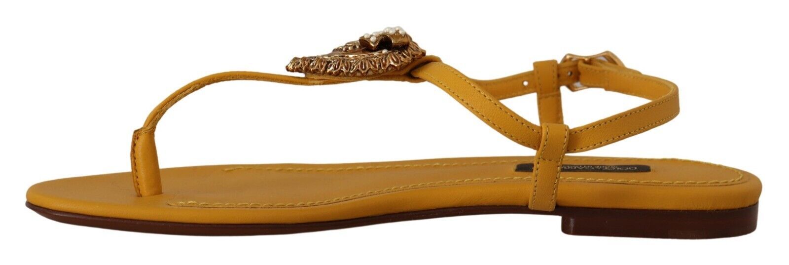 Pair of yellow sandals with straps and buckles