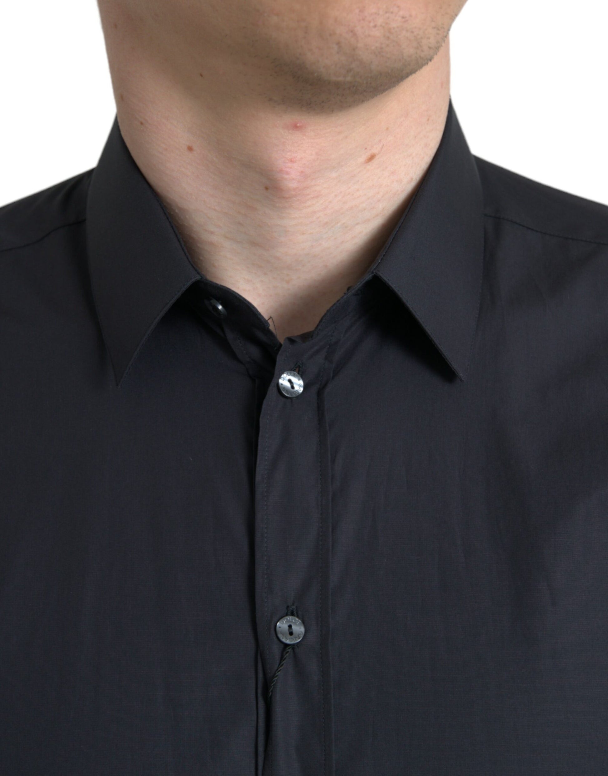 Man wearing black shirt with collar and buttons