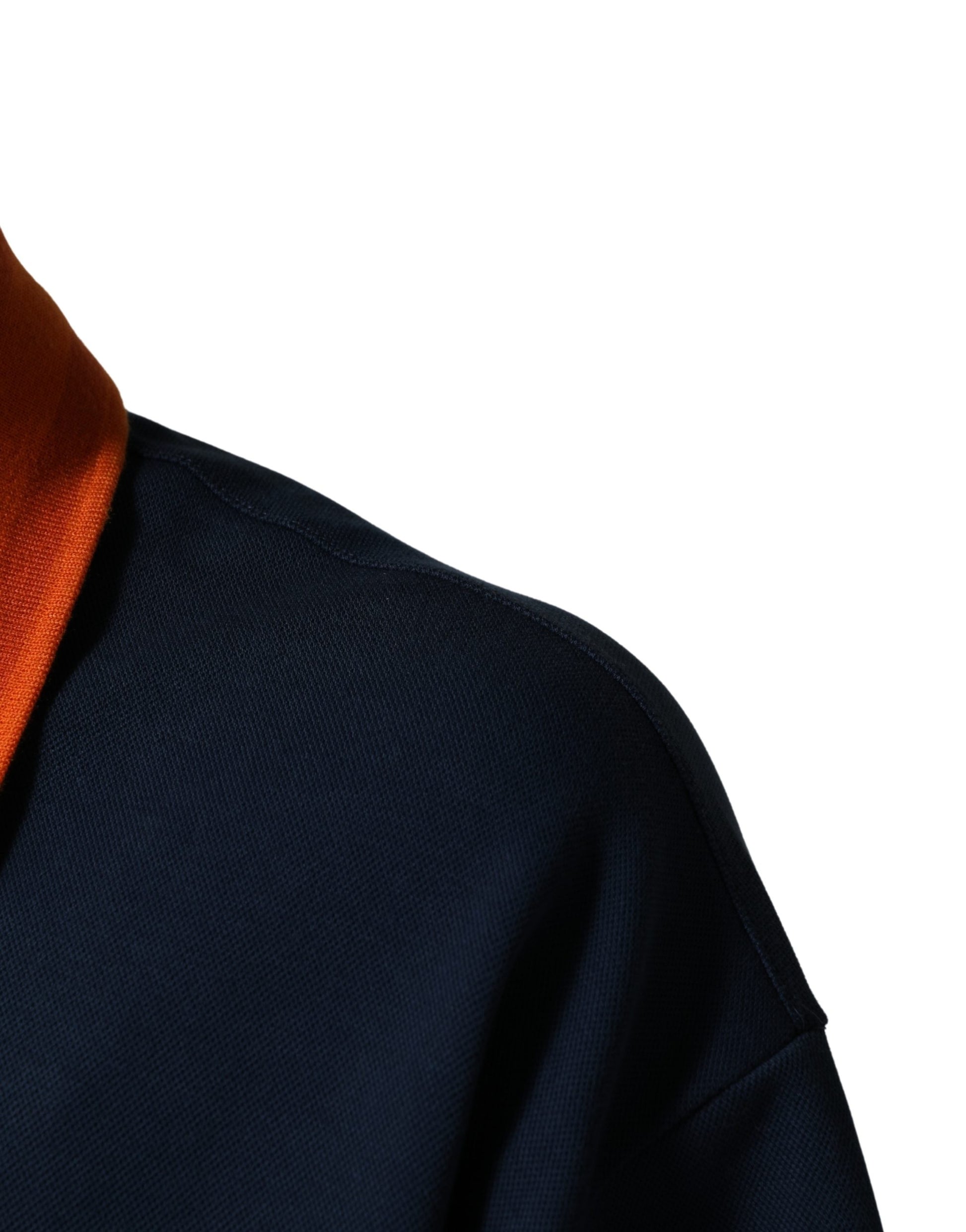 A person wearing a dark blue jacket with an orange collar