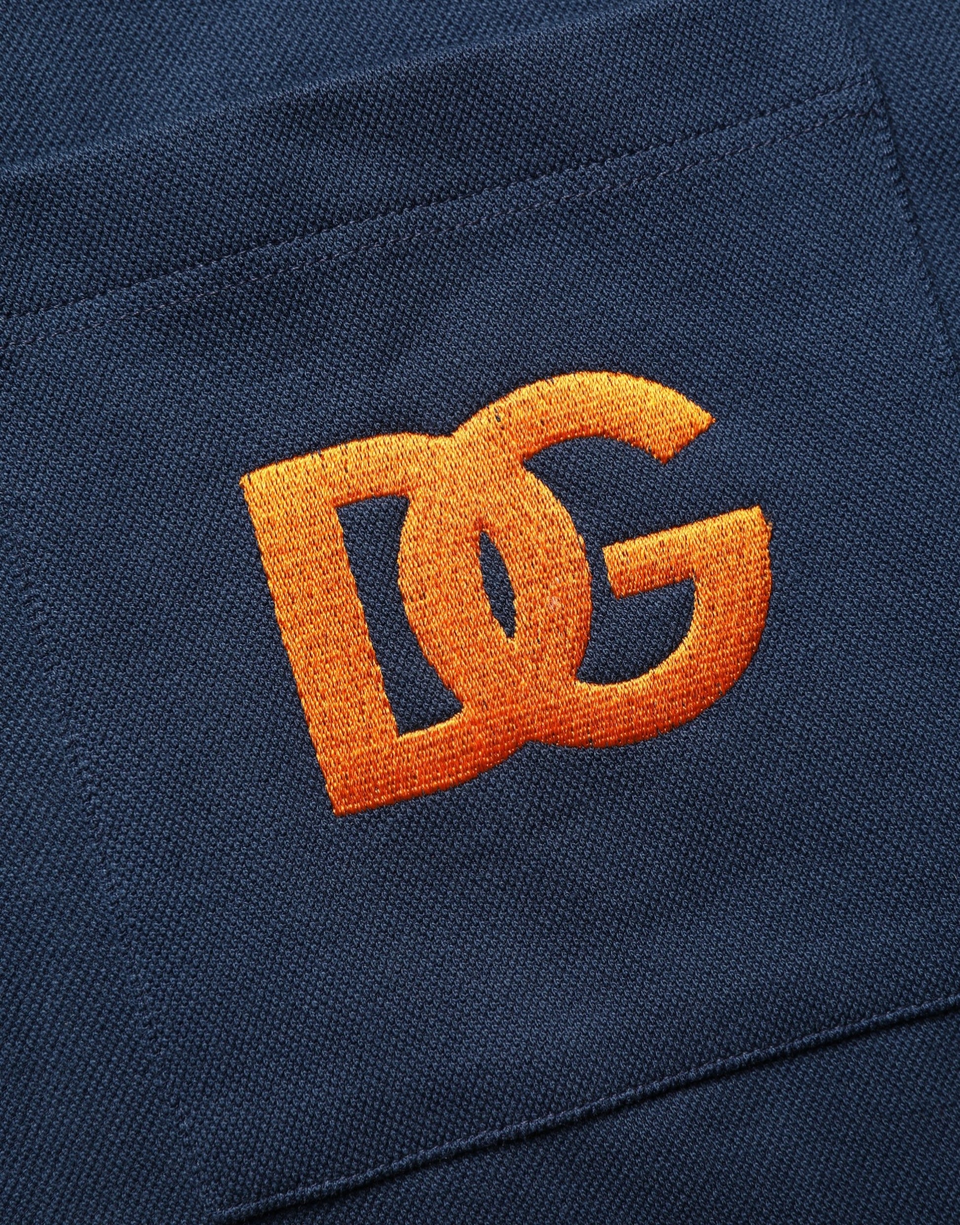 Blue denim jacket with orange embroidered letters