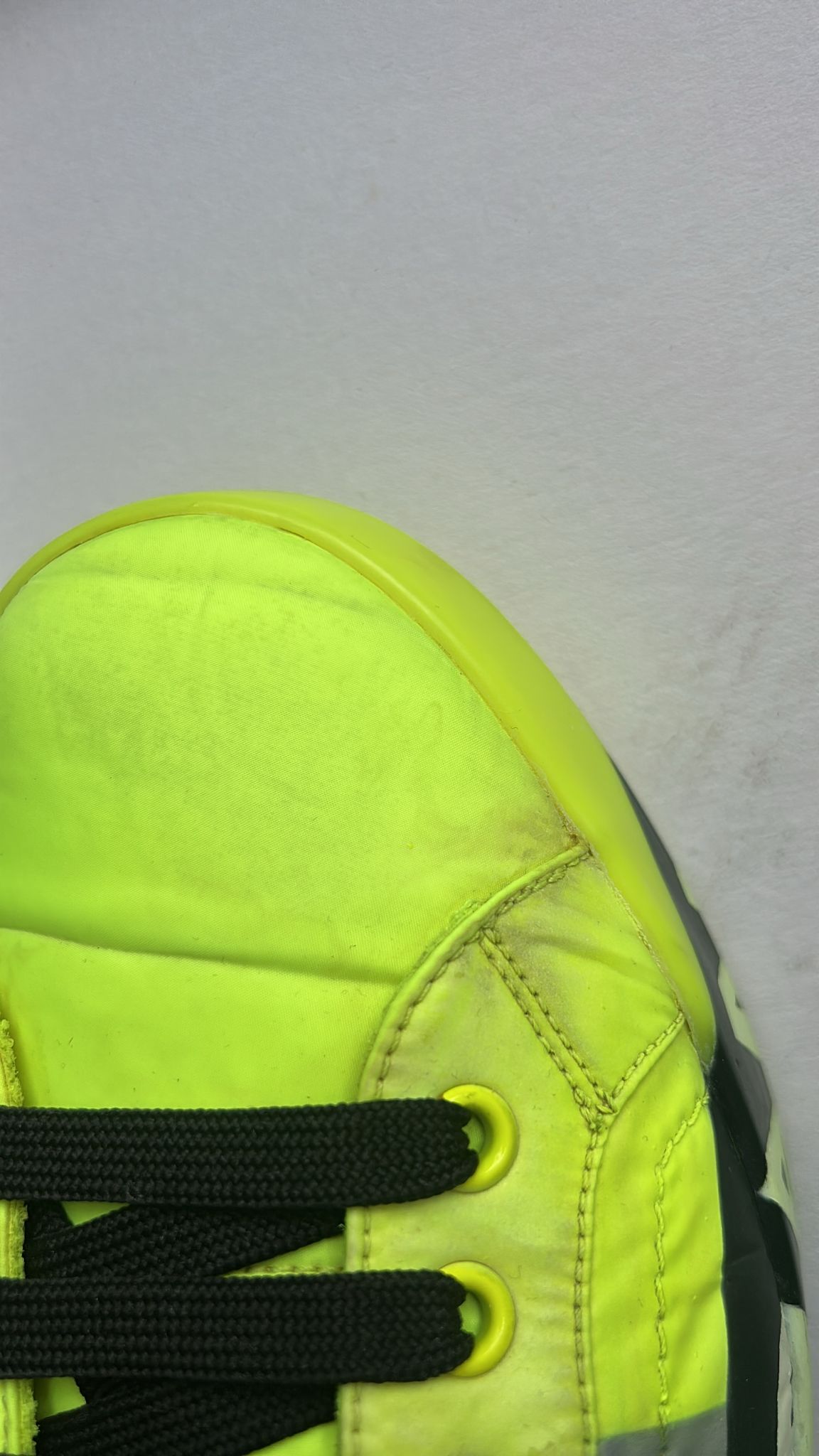 Yellow shoe on white surface