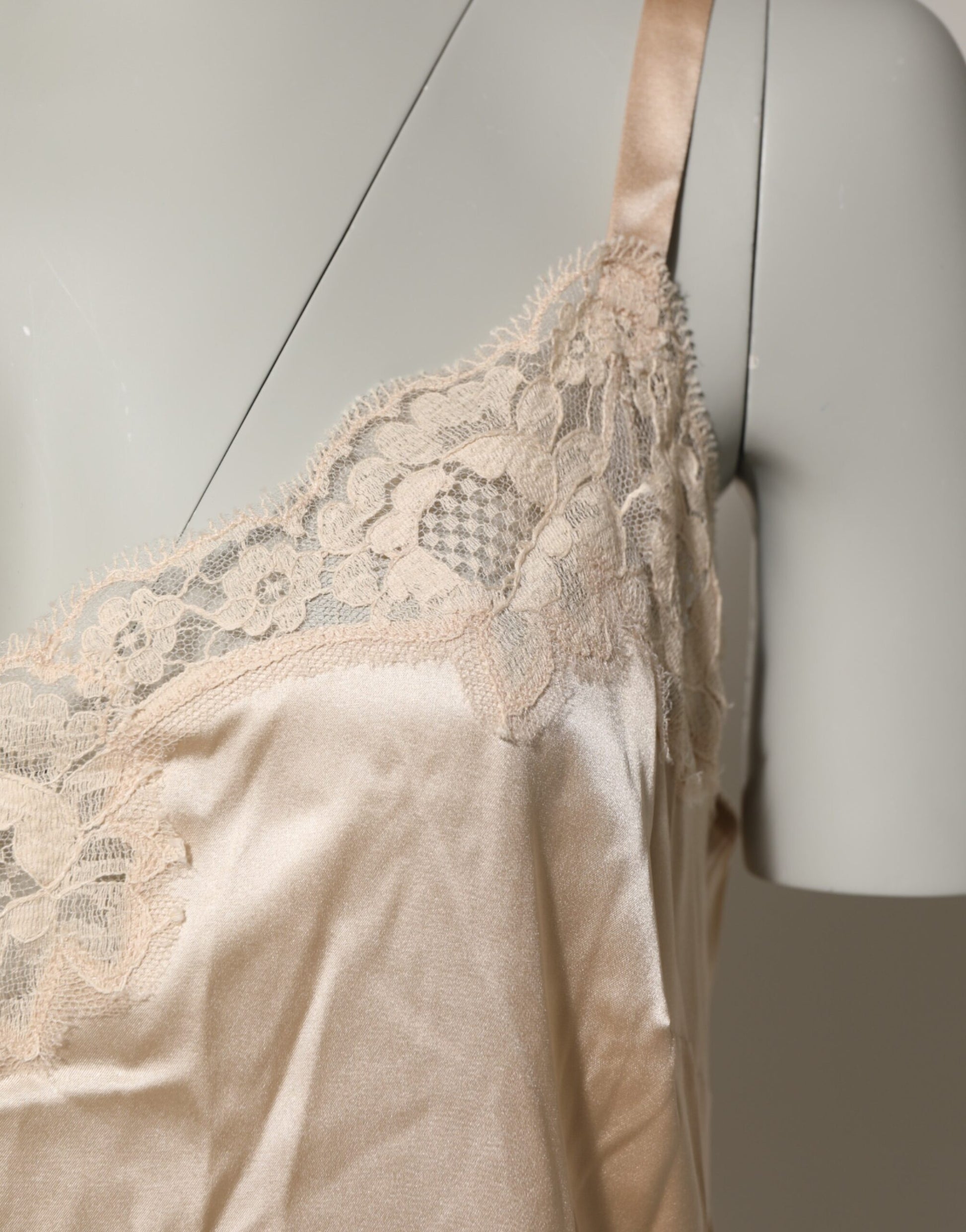 A beige lace trimmed chemise with a silk blend