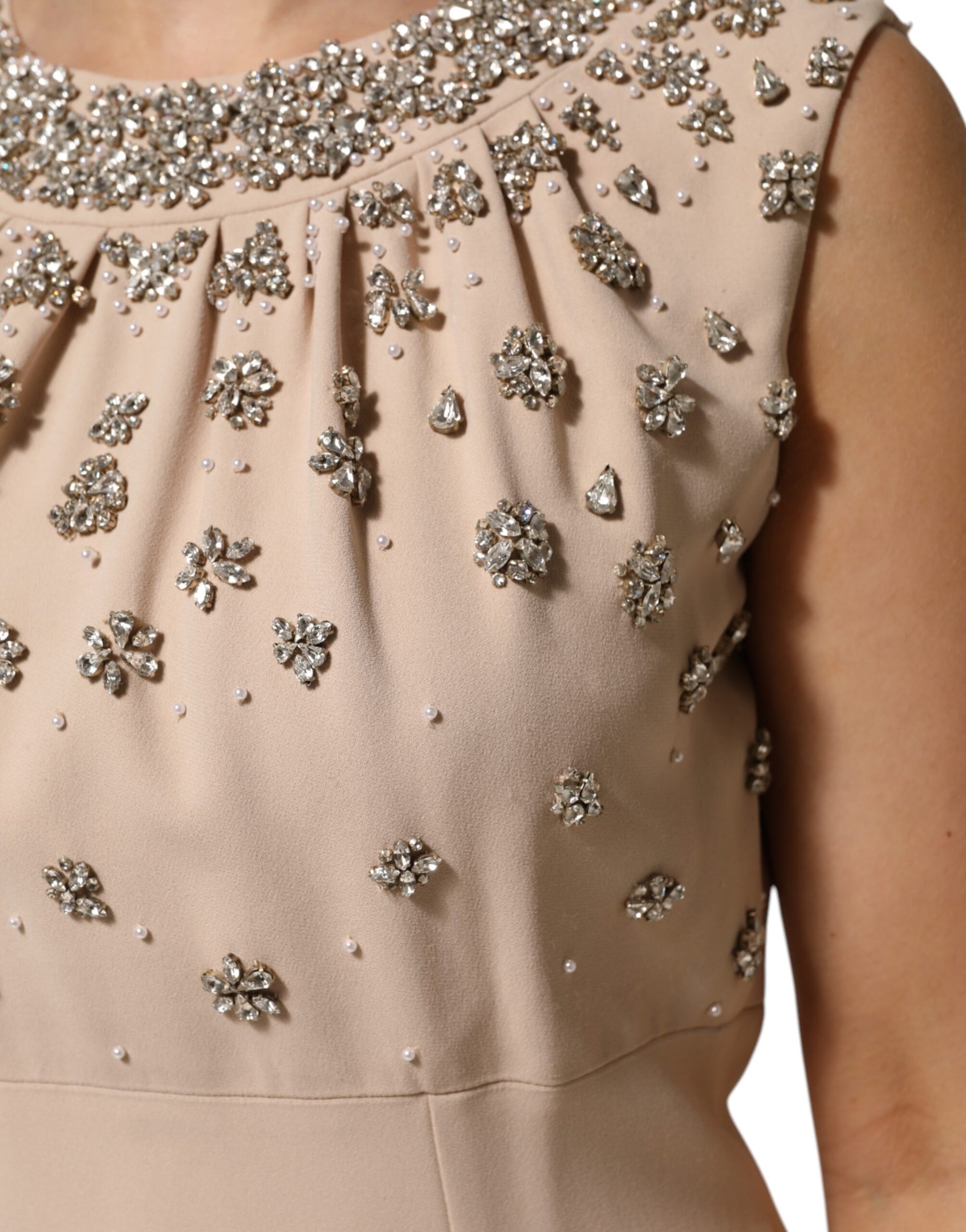 A beaded crystal embellished dress in nude ecru color