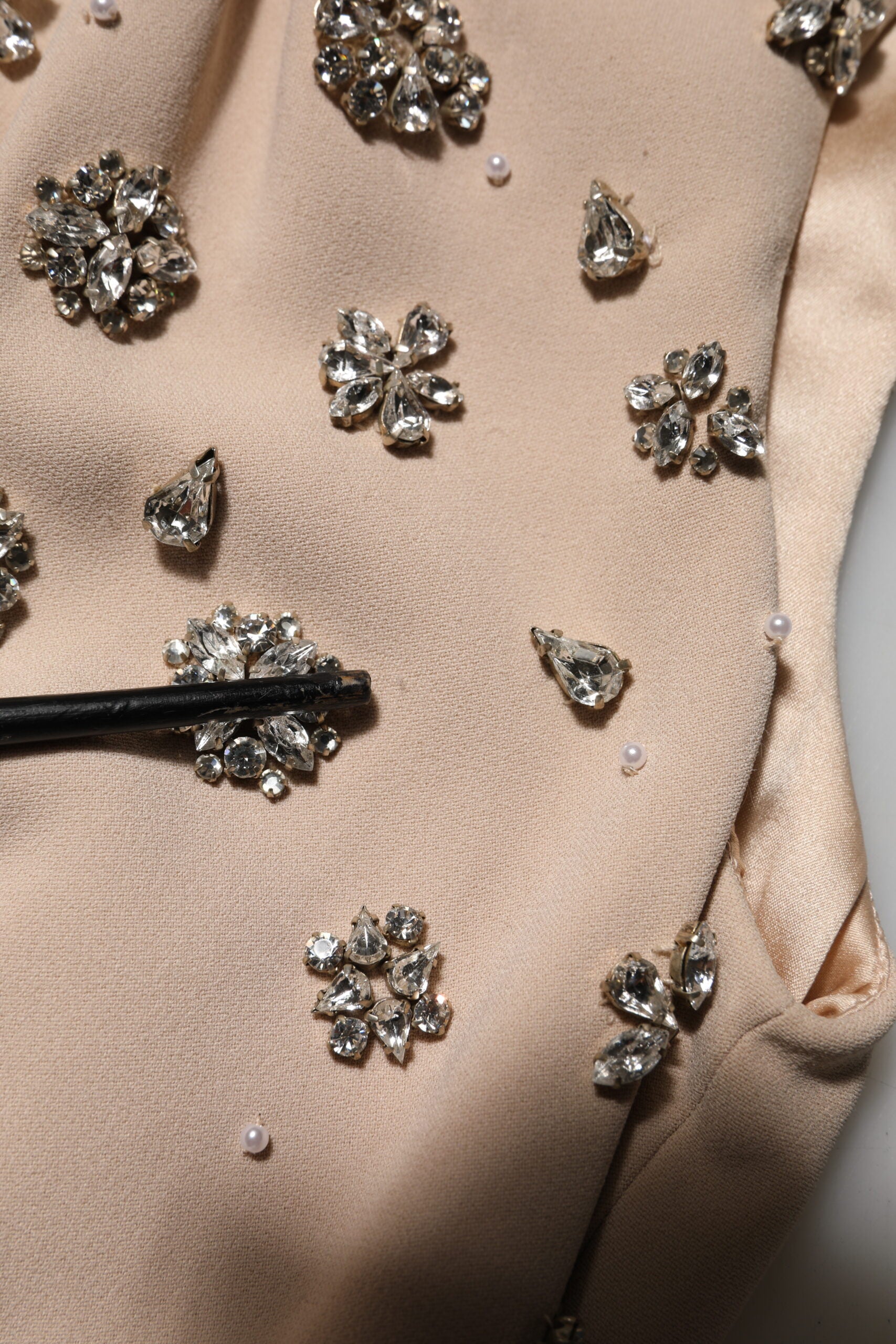 A beaded crystal embellished dress with a nude ecru color