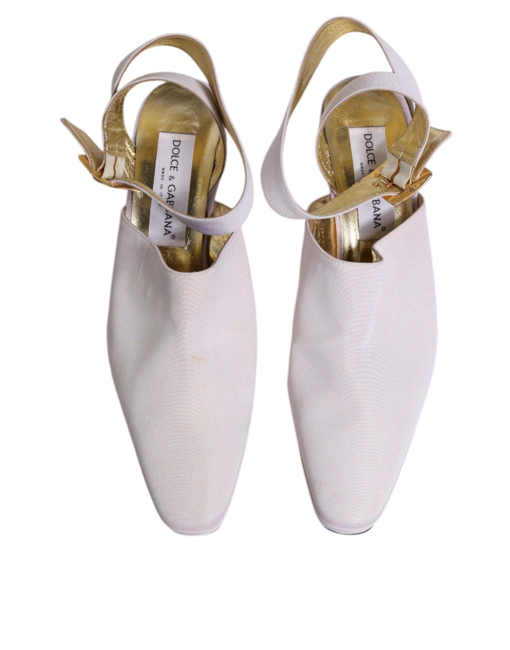 Pair of white ballet shoes with gold trim