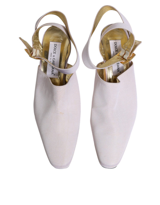Pair of white ballet shoes with gold trim