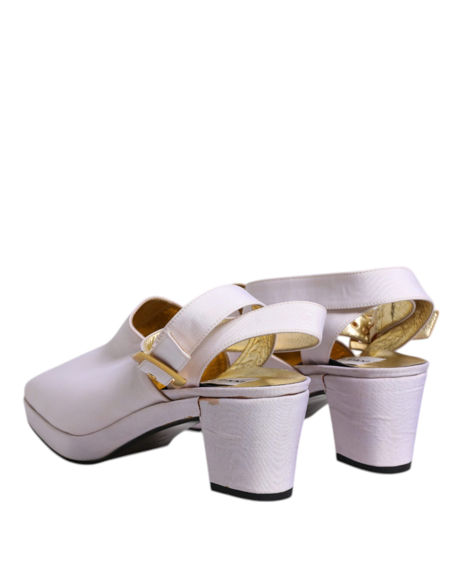Pair of women's high heel shoes with gold accents