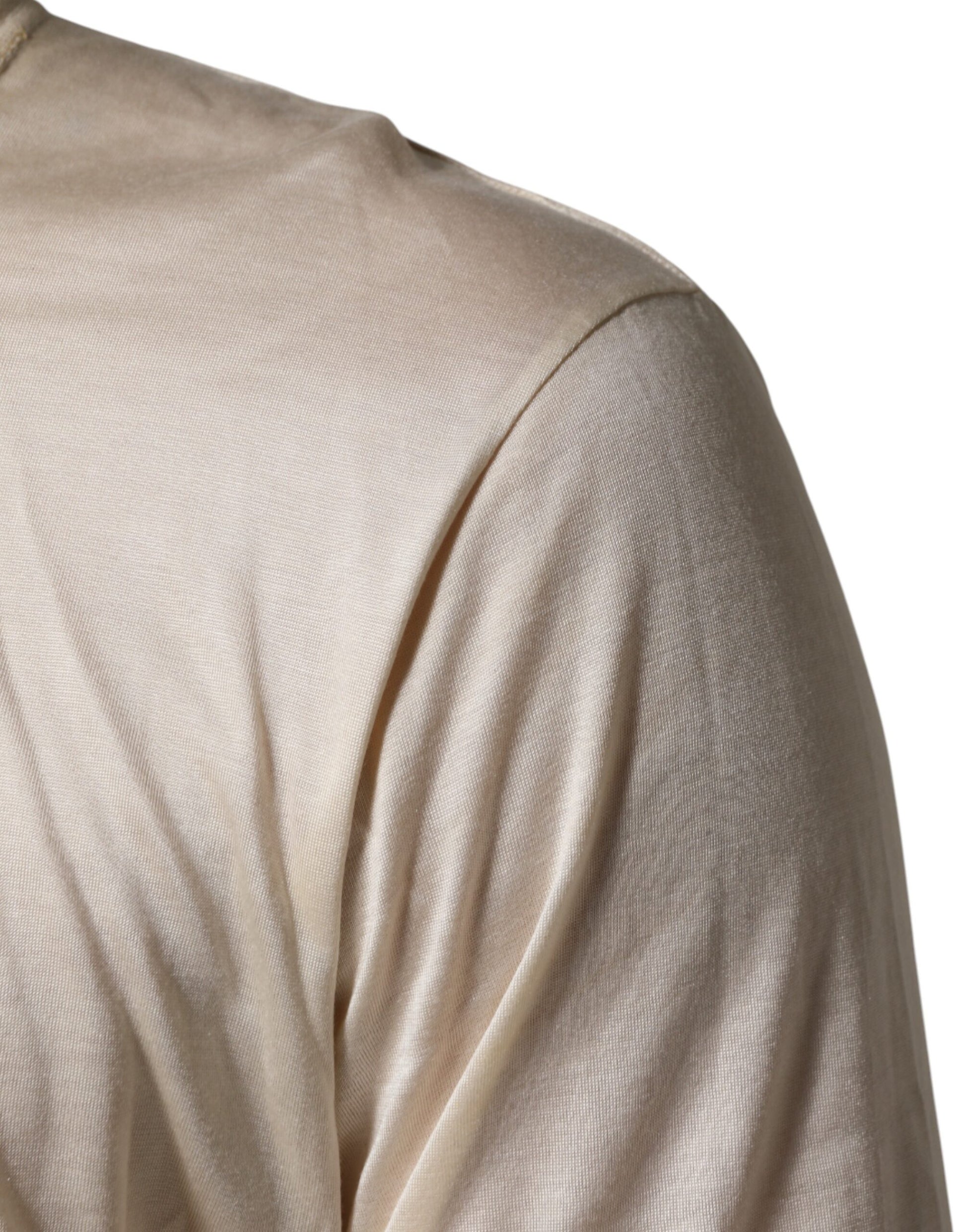 Shoulder of a person wearing a beige top