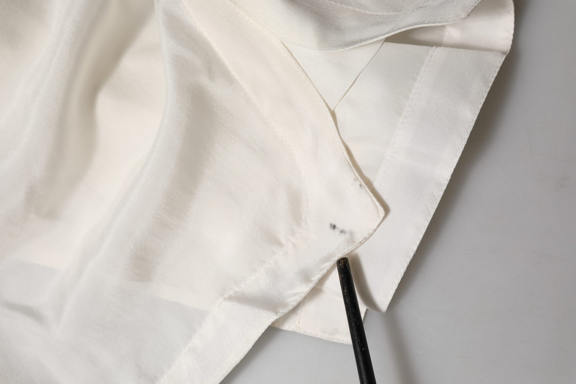 White fabric with a tear in the corner