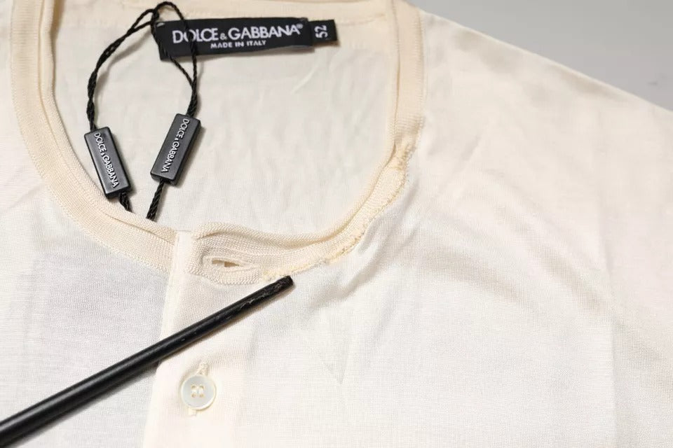 Yellow sweater on hanger with black earbuds attached to tag