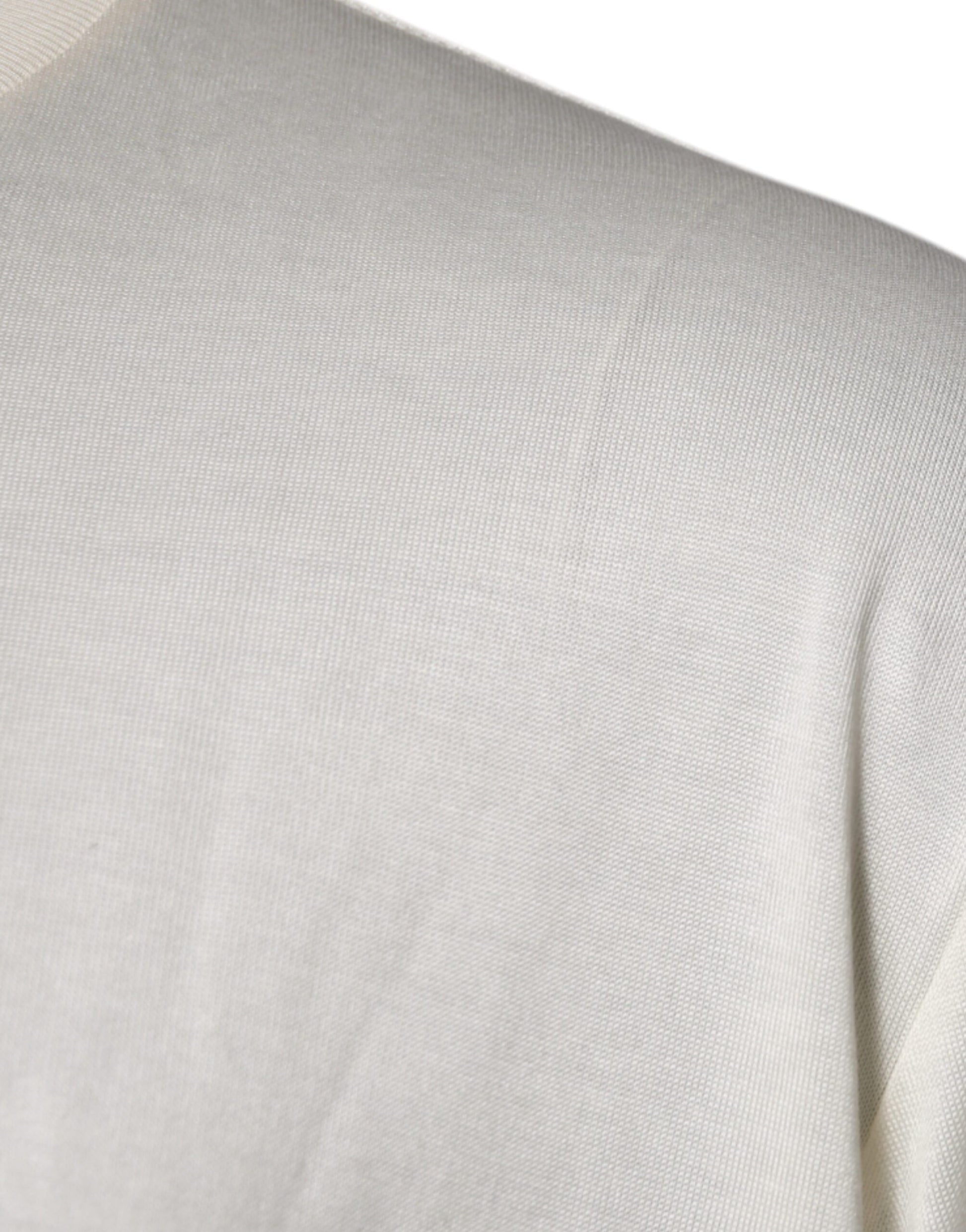 A close-up view of a person's shoulder area wearing a light-colored garment with horizontal stripes or lines