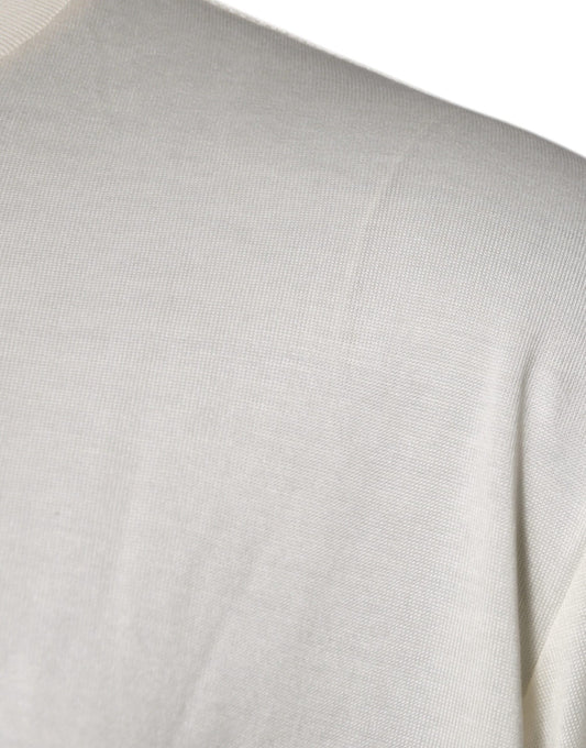 A close-up view of a person's shoulder area wearing a light-colored garment with horizontal stripes or lines