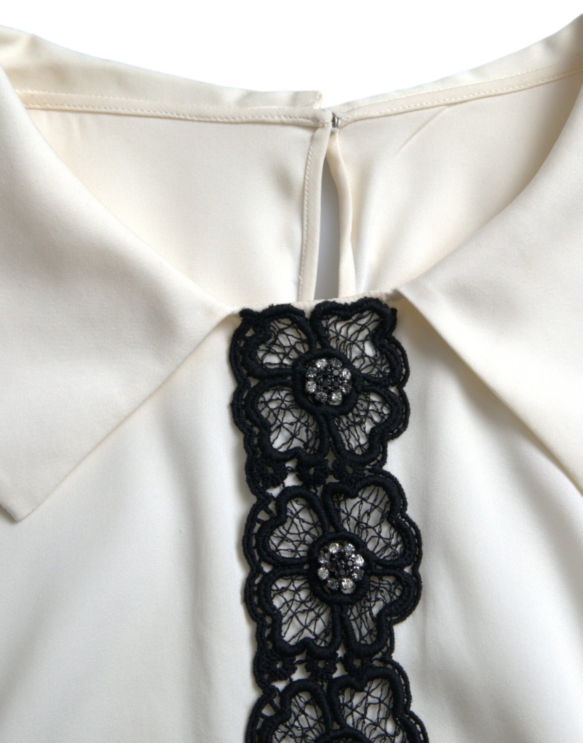 White blouse with black lace trim at neckline