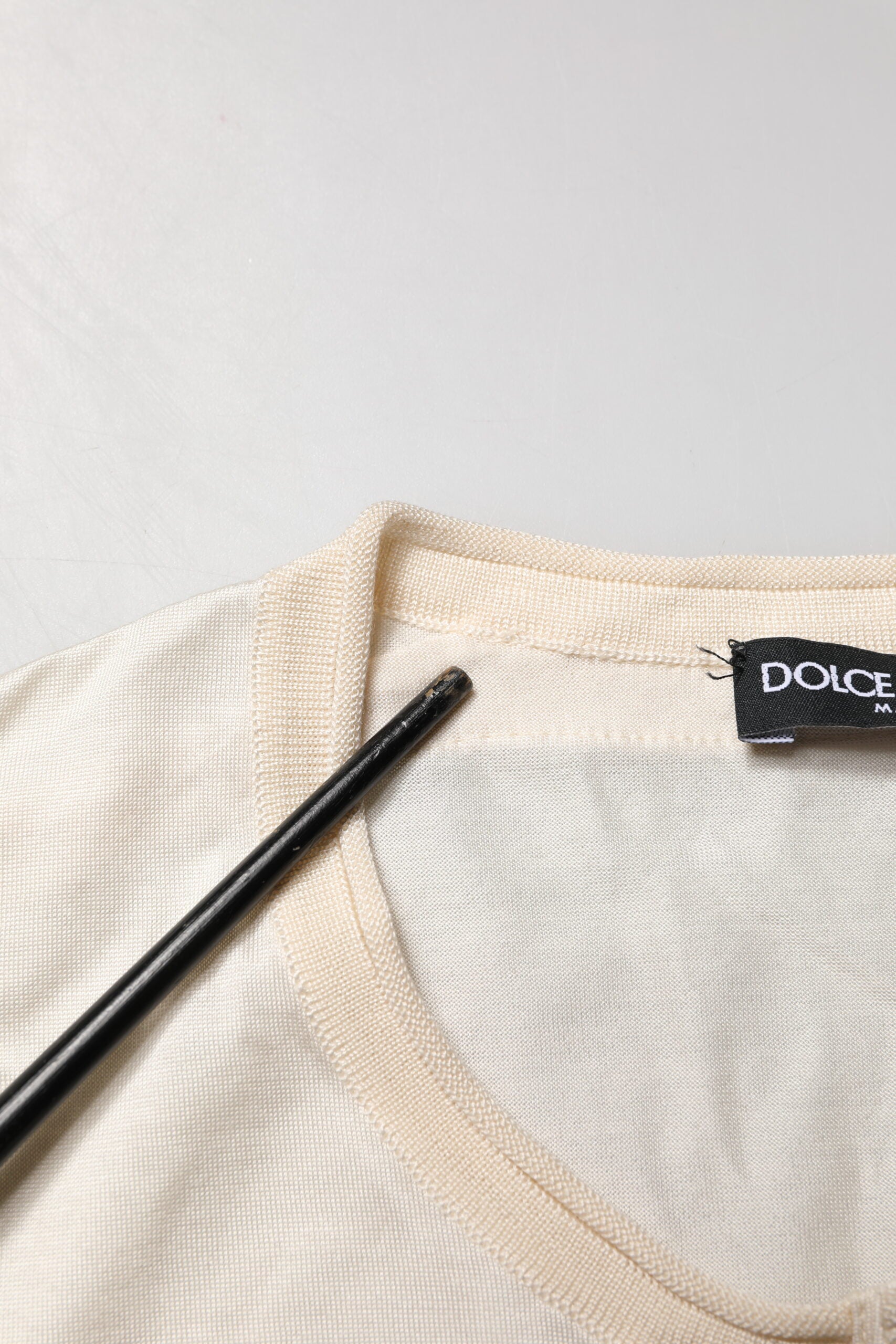 Tan knit sweater on hanger