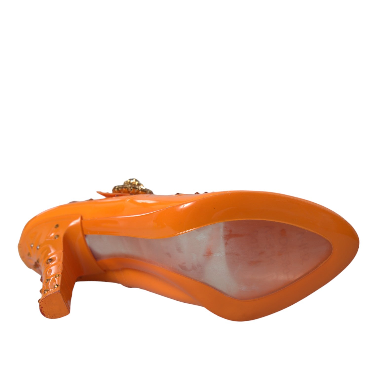 Orange shoe with a pointed toe and a strap across the top