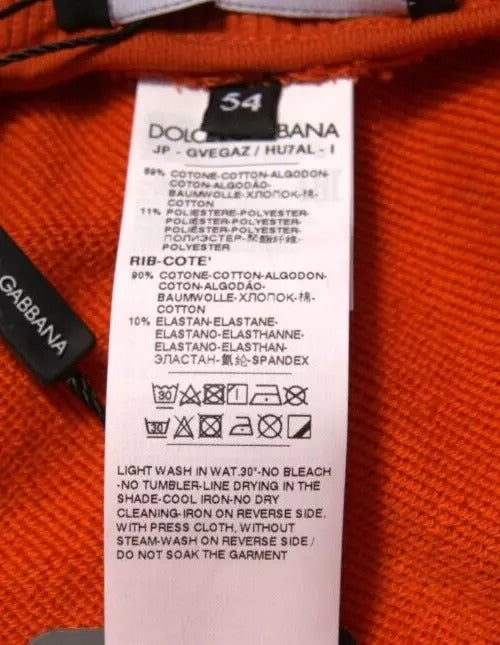 A pair of orange cotton blend men's bermuda shorts with a label that reads "Dolce & Gabbana." The shorts are