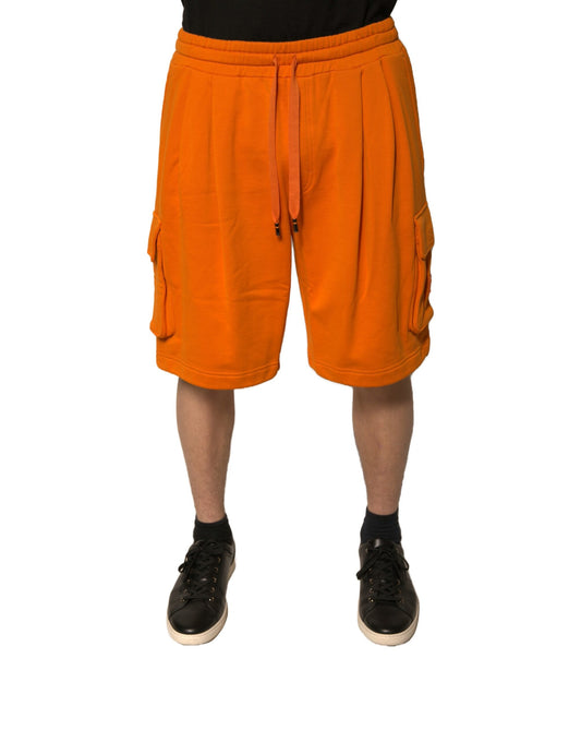 A pair of orange cotton men's casual cargo bermuda shorts