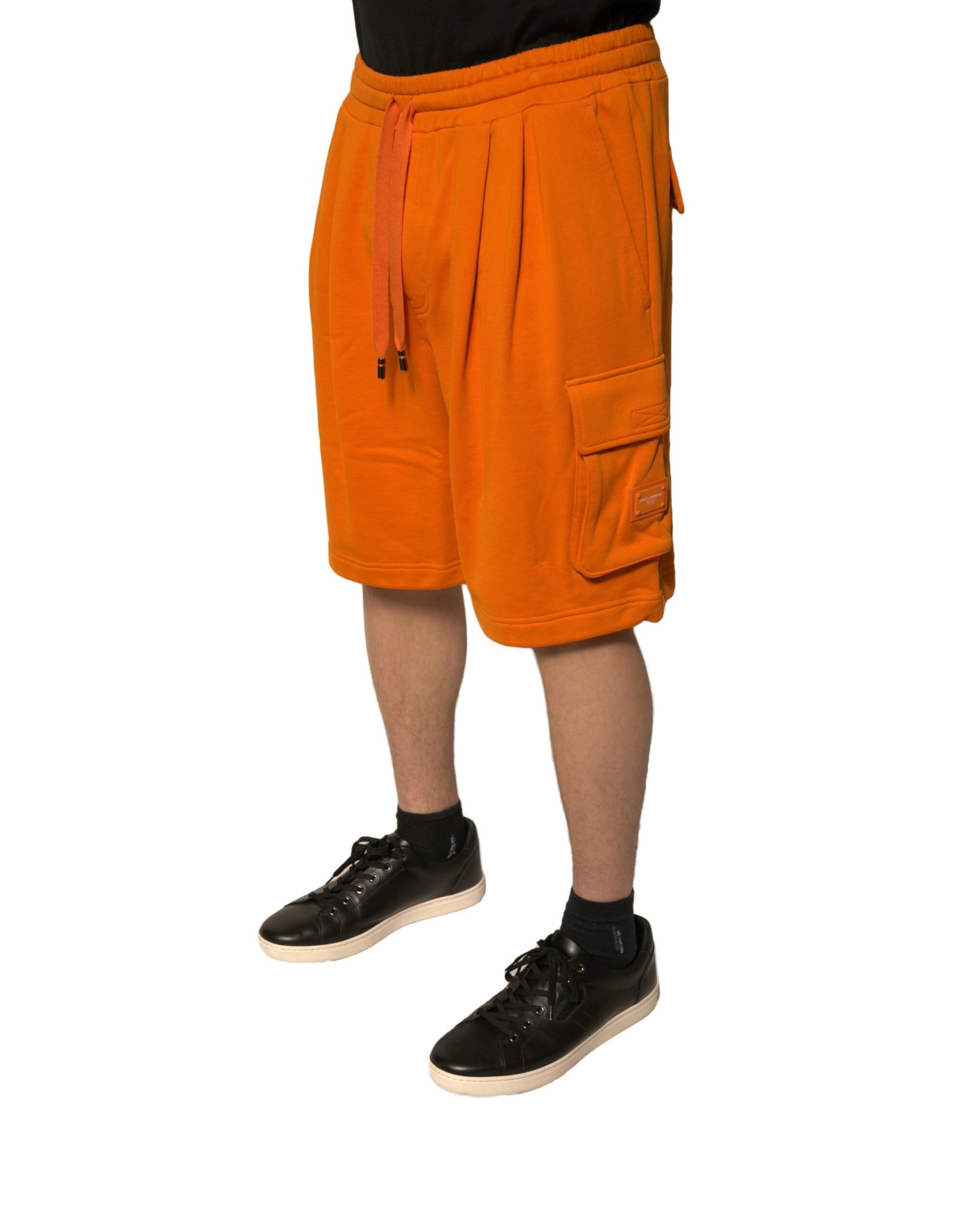 A pair of orange cotton men's casual cargo bermuda shorts