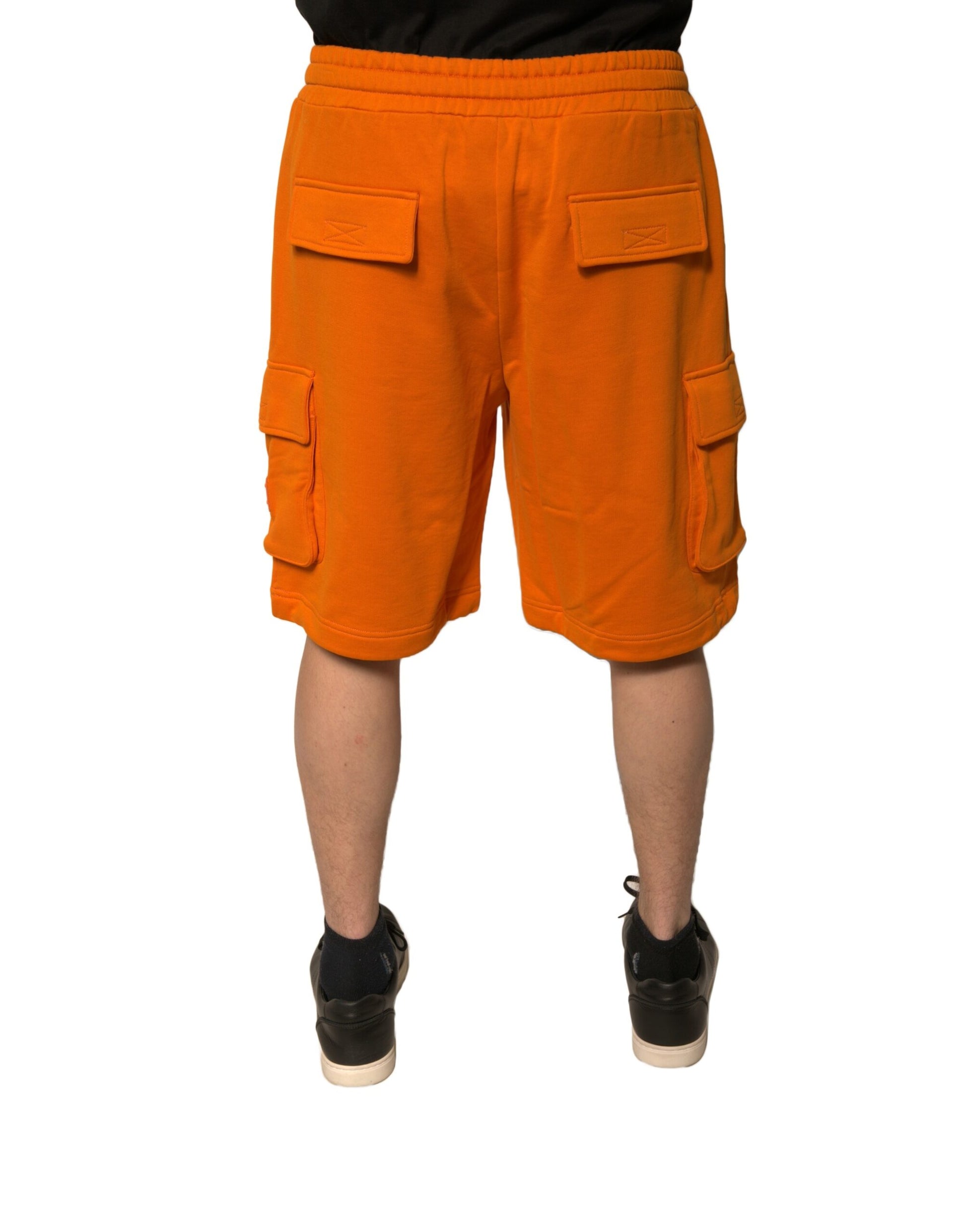Orange cargo shorts with pockets, worn by a mannequin
