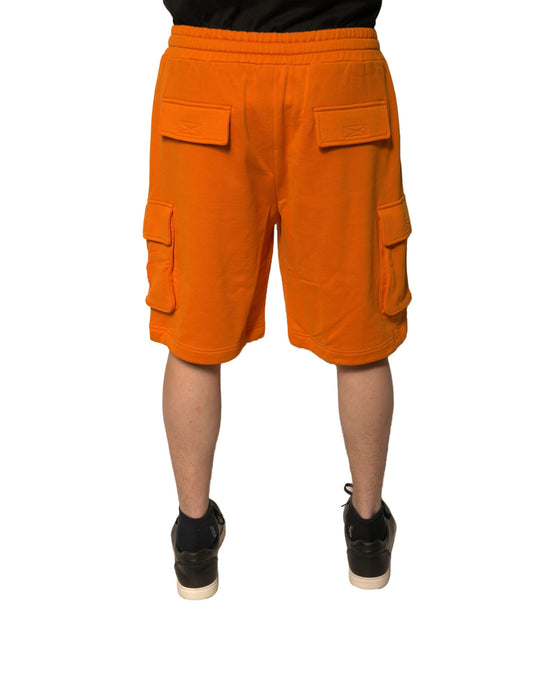 Orange cargo shorts with pockets, worn by a mannequin