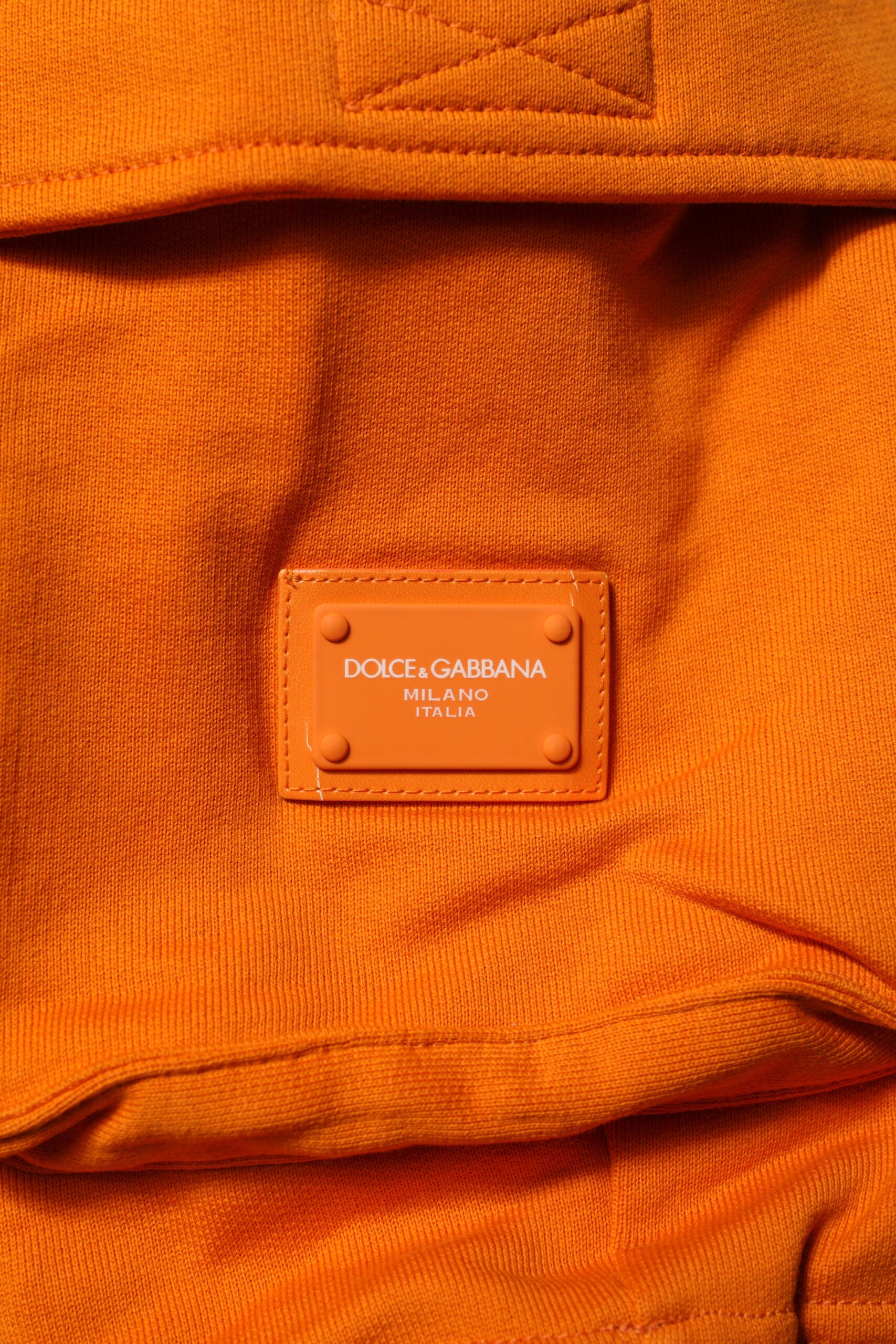 Orange fabric with a label that reads "Dolce & Gabbana"